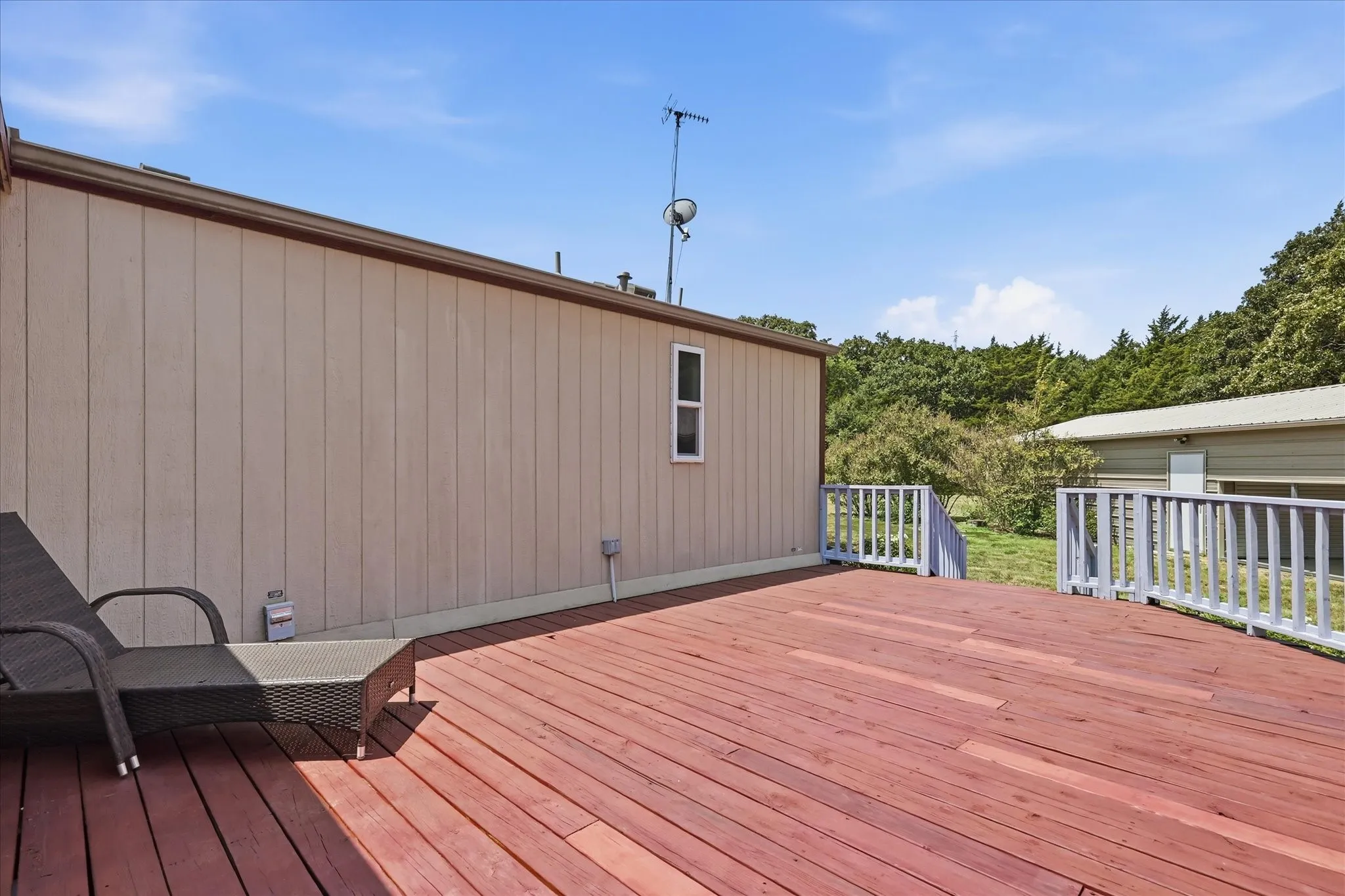 Expansive composite deck featuring rich wood-finish decking with ample space for outdoor entertaining and relaxation