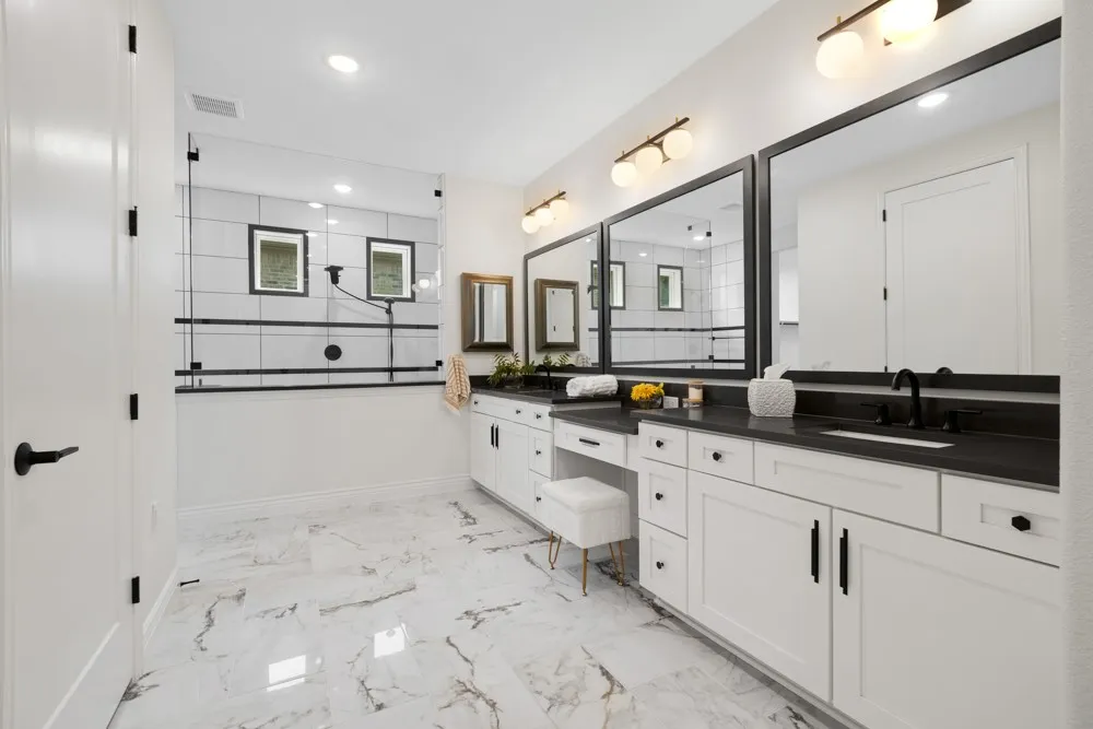 Impactful Primary Bathroom has Dual Sinks and Vanity