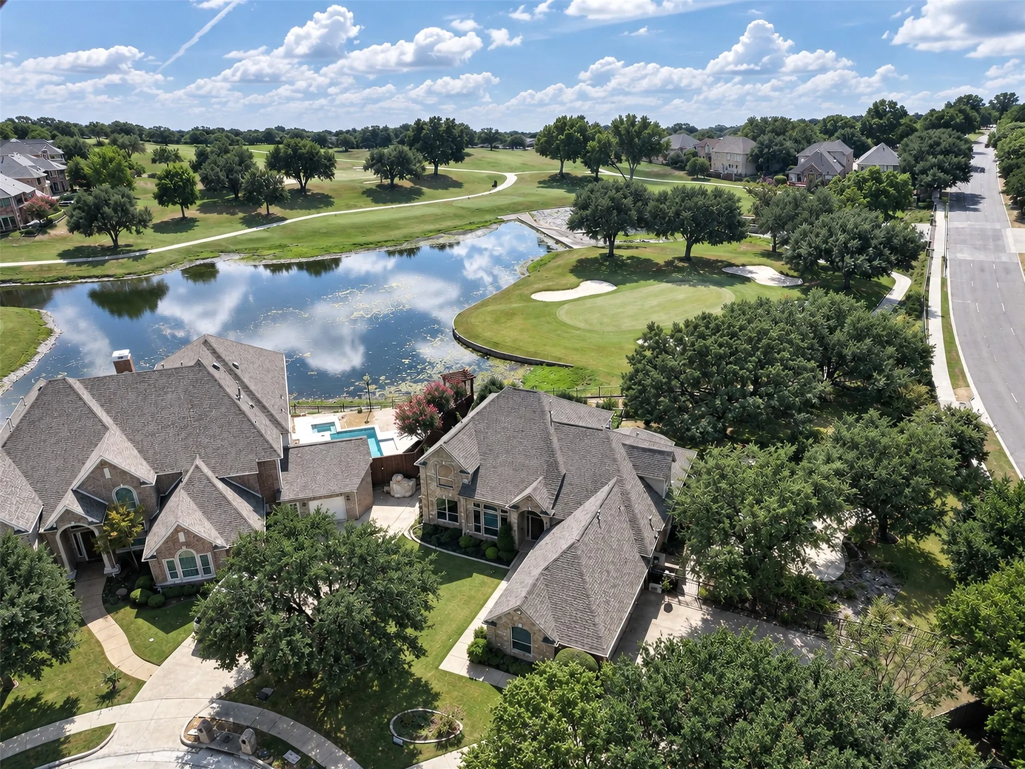 Property featuring a private swimming pool, direct golf course access, and a waterside setting