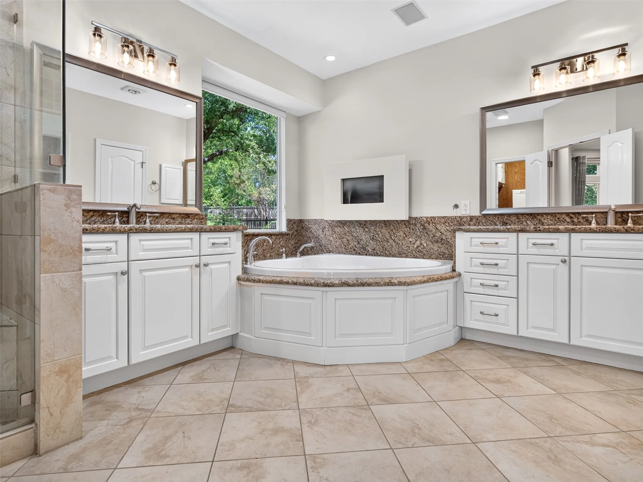 Dual vanity with white cabinetry, stone countertops, and integrated sinks