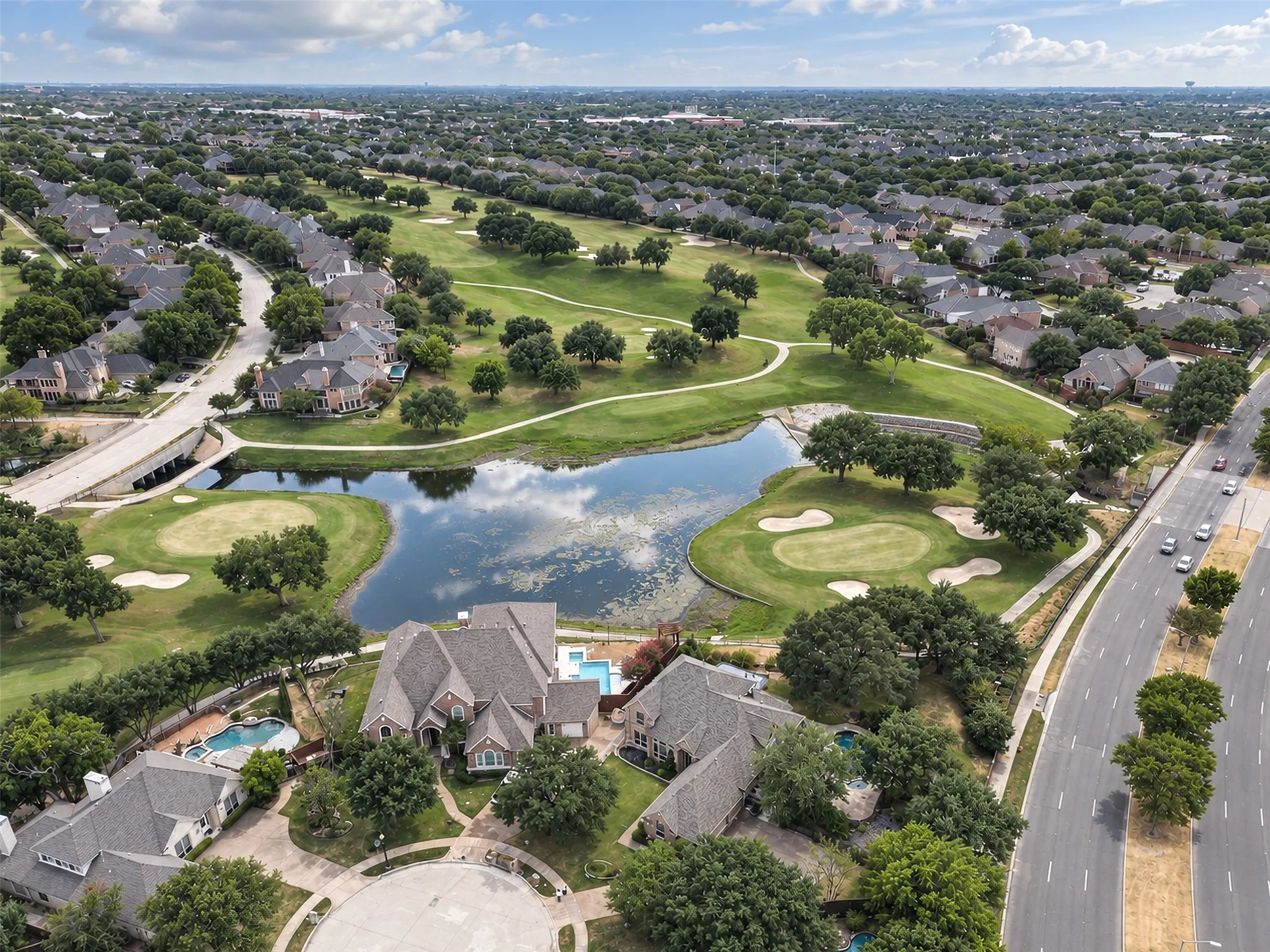 Lush green golf course, tranquil water features, mature trees, and private swimming pools