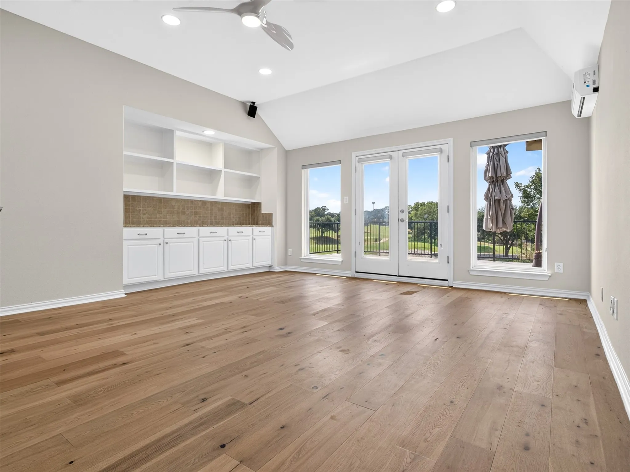 Vaulted ceiling featuring recessed lighting and a ceiling fan