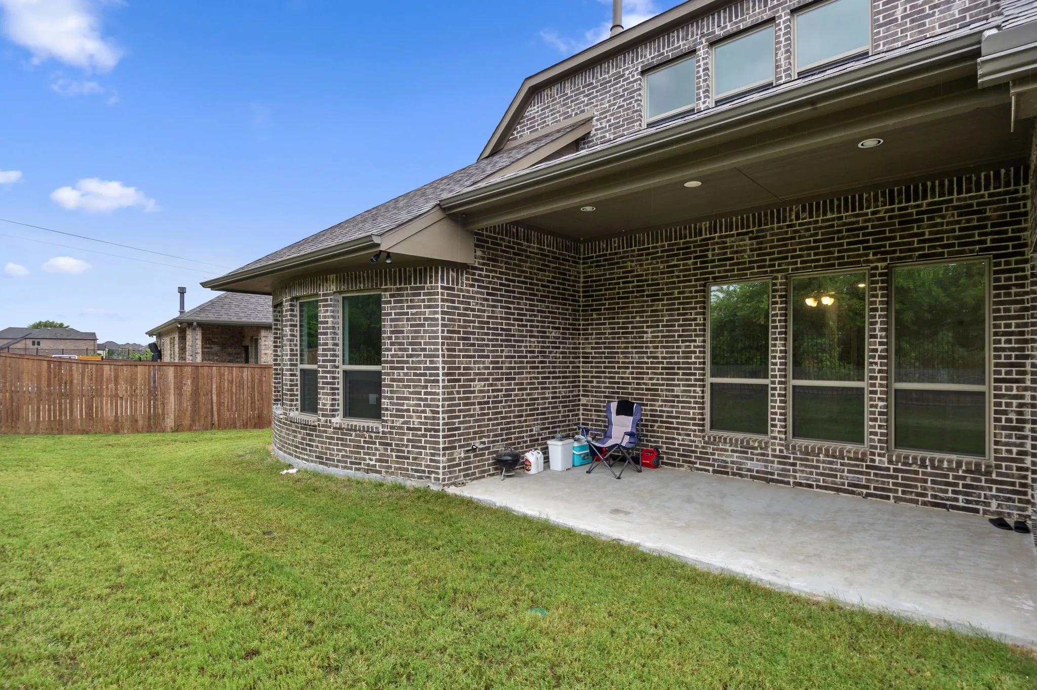 Rear view of house featuring a lawn and a patio area