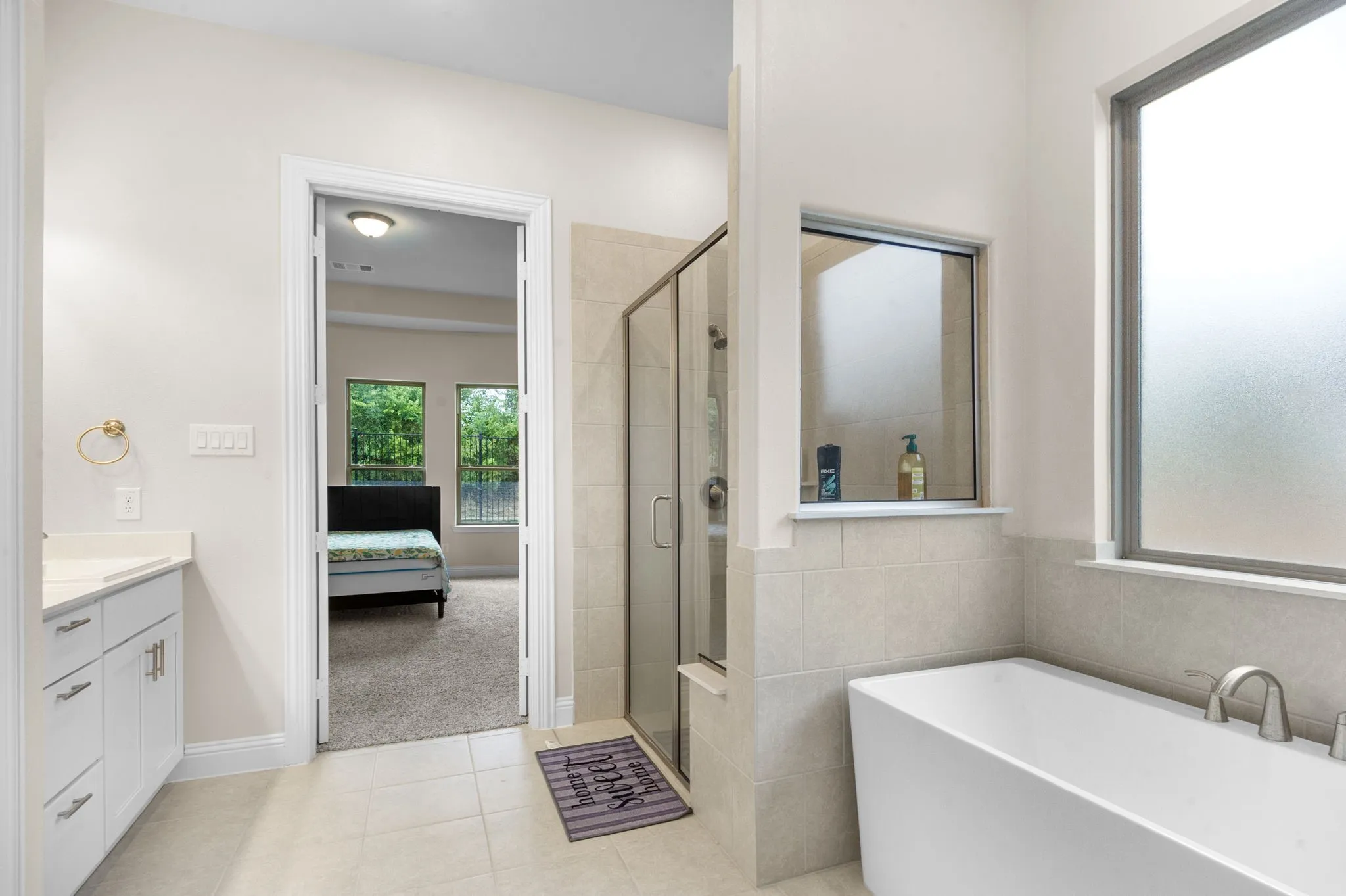 Bathroom featuring tile patterned flooring, vanity, and independent shower and bath