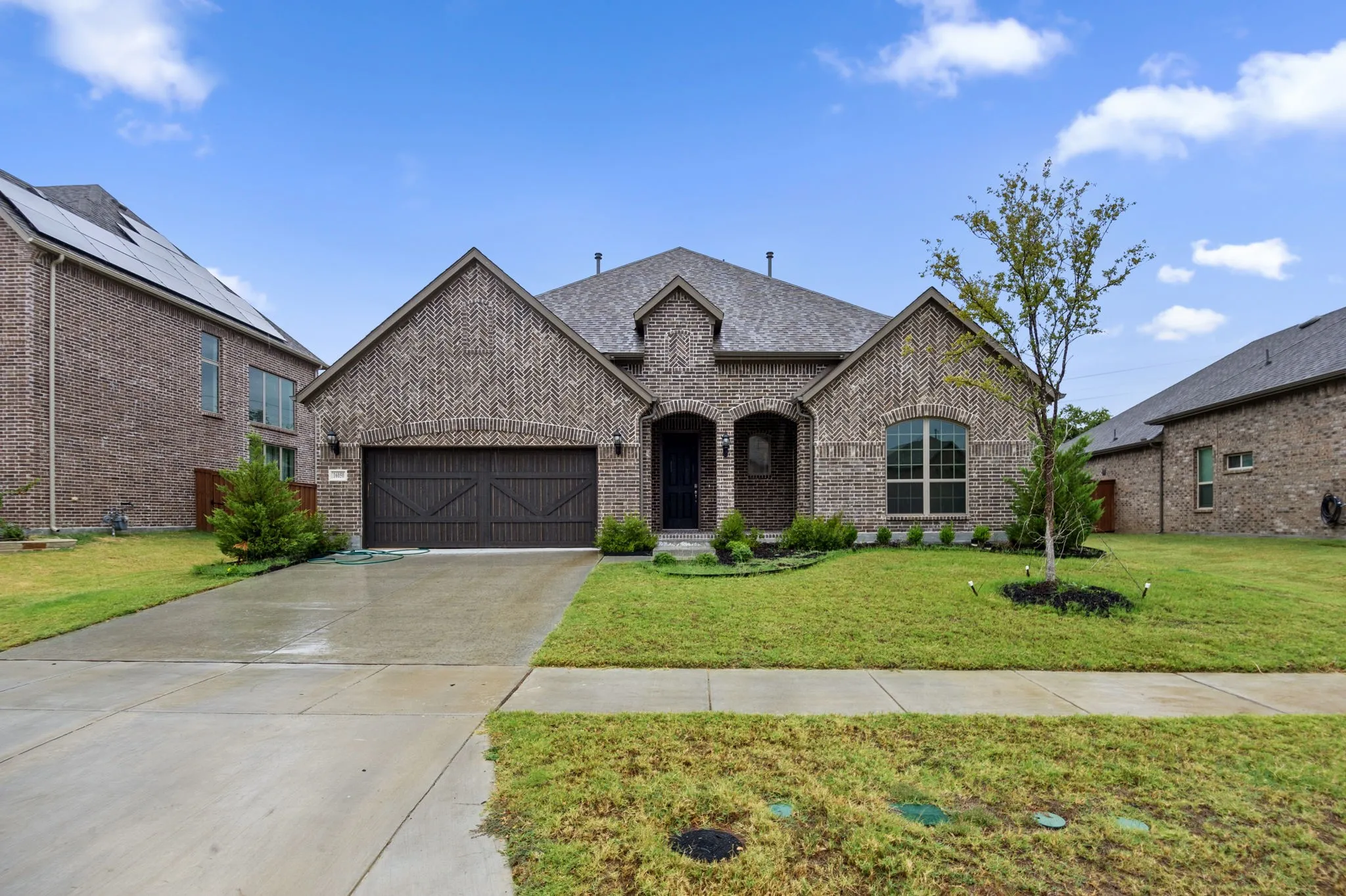 Megatel 1.5 story house with a front yard and a garage