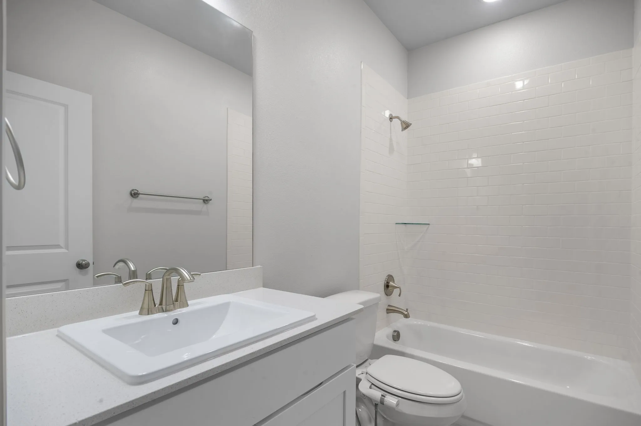 Full bathroom featuring tiled shower / bath, toilet, and vanity