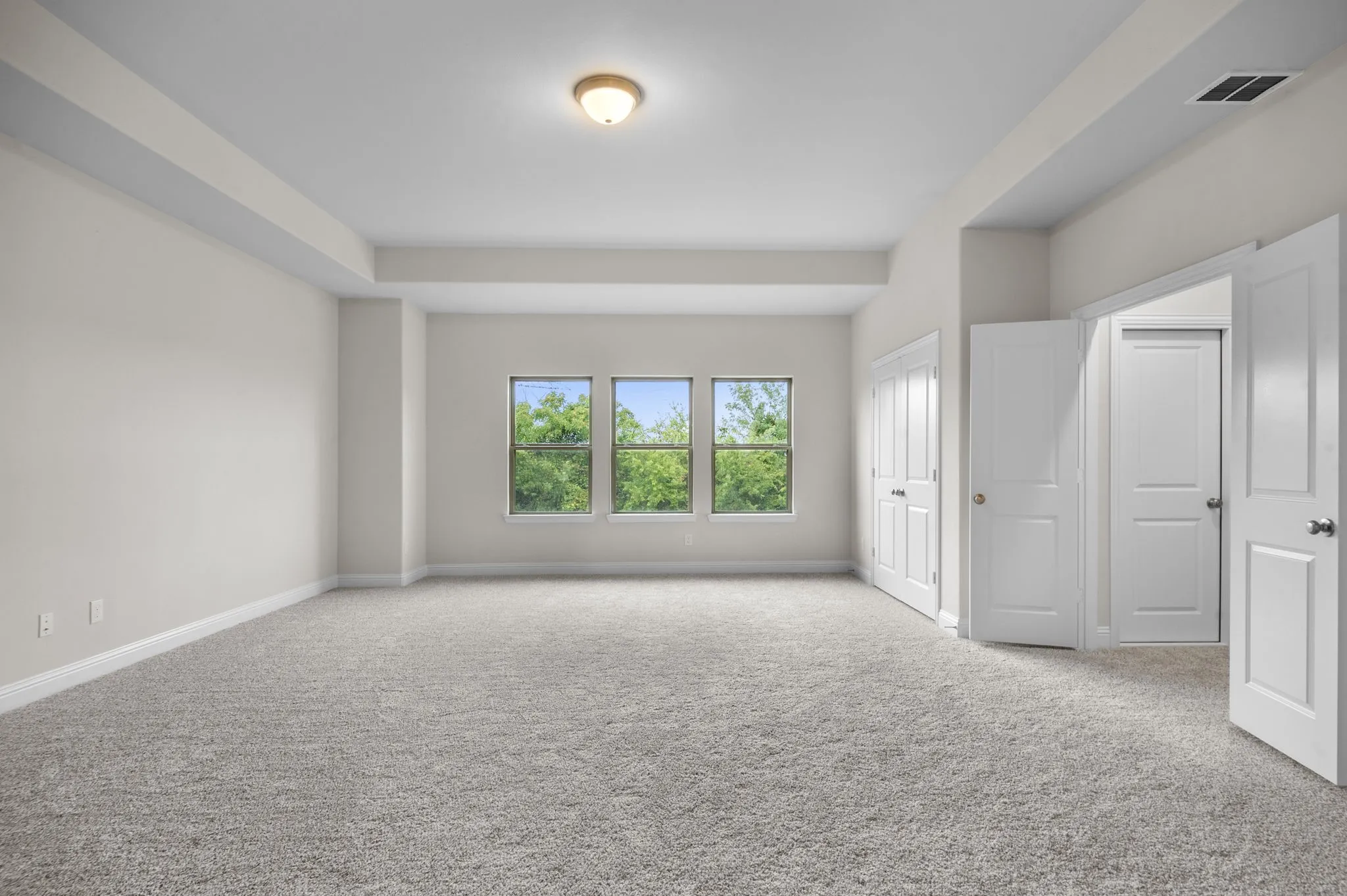 Unfurnished room featuring light carpet