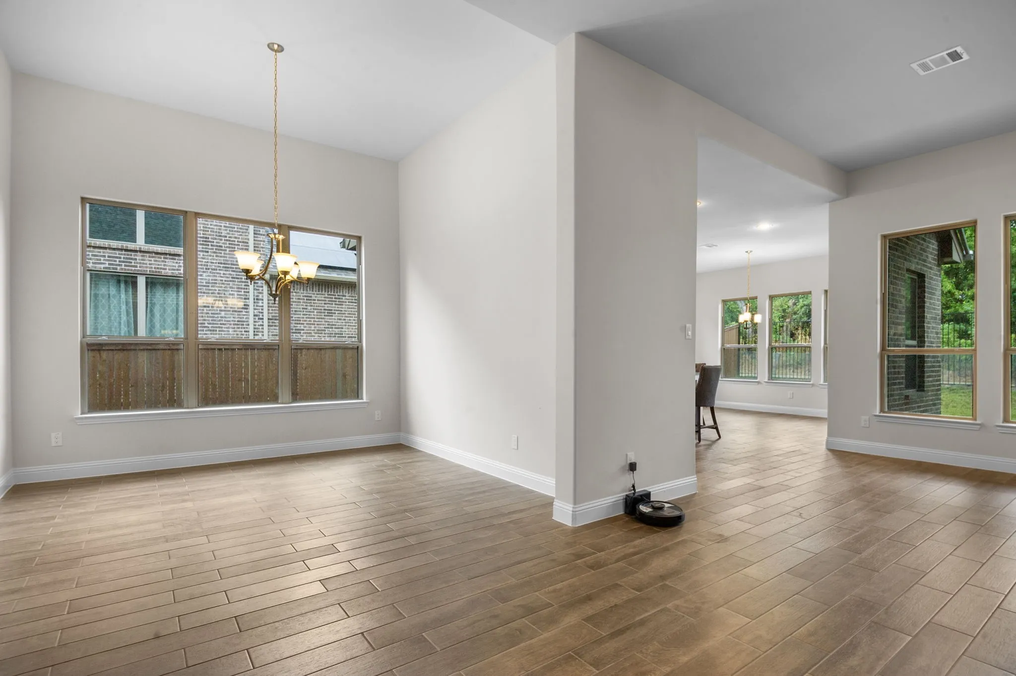 Unfurnished dining area featuring a notable chandelier and hardwood / wood-style flooring