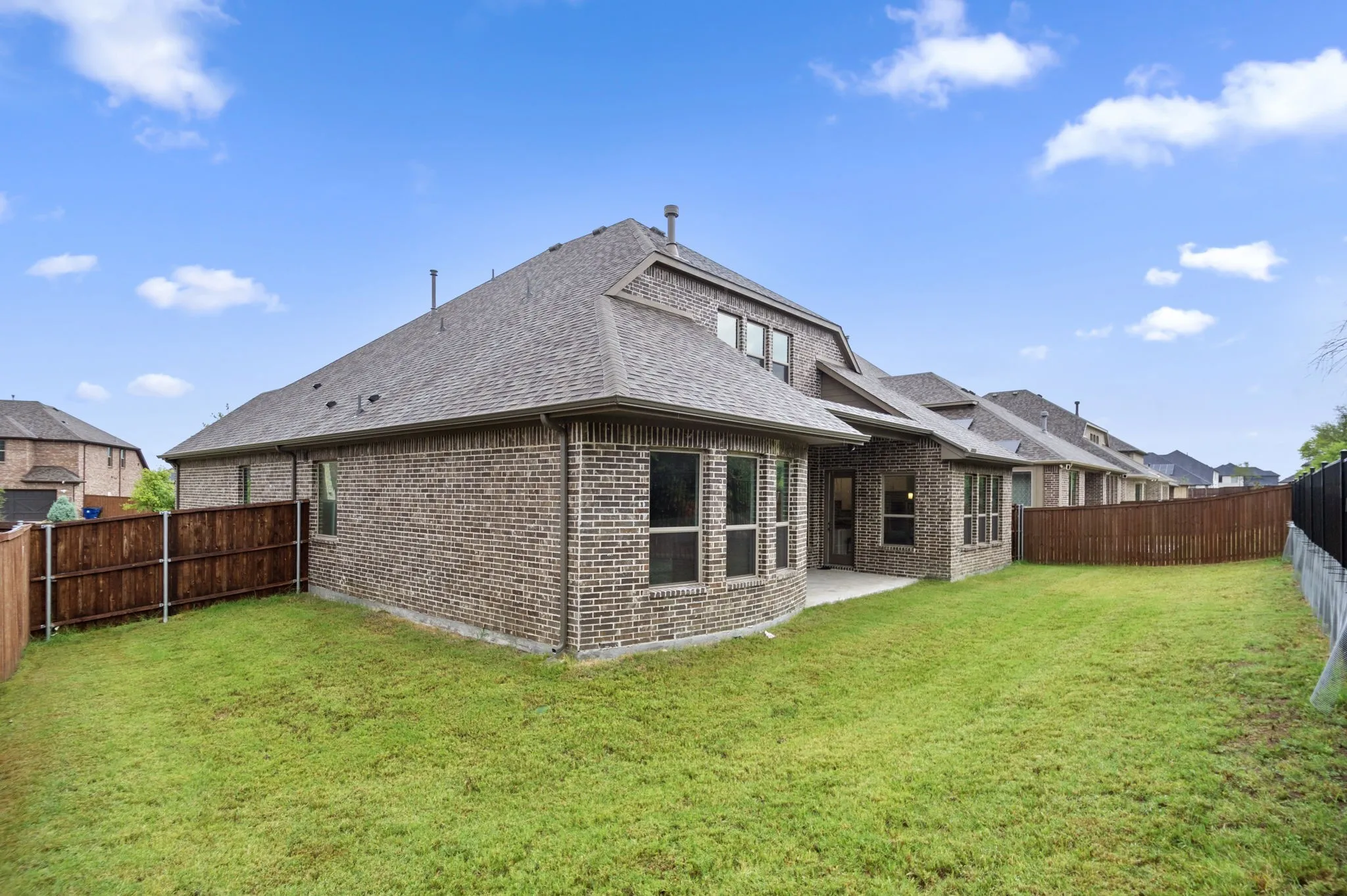 Rear view of property featuring a patio area and a yard