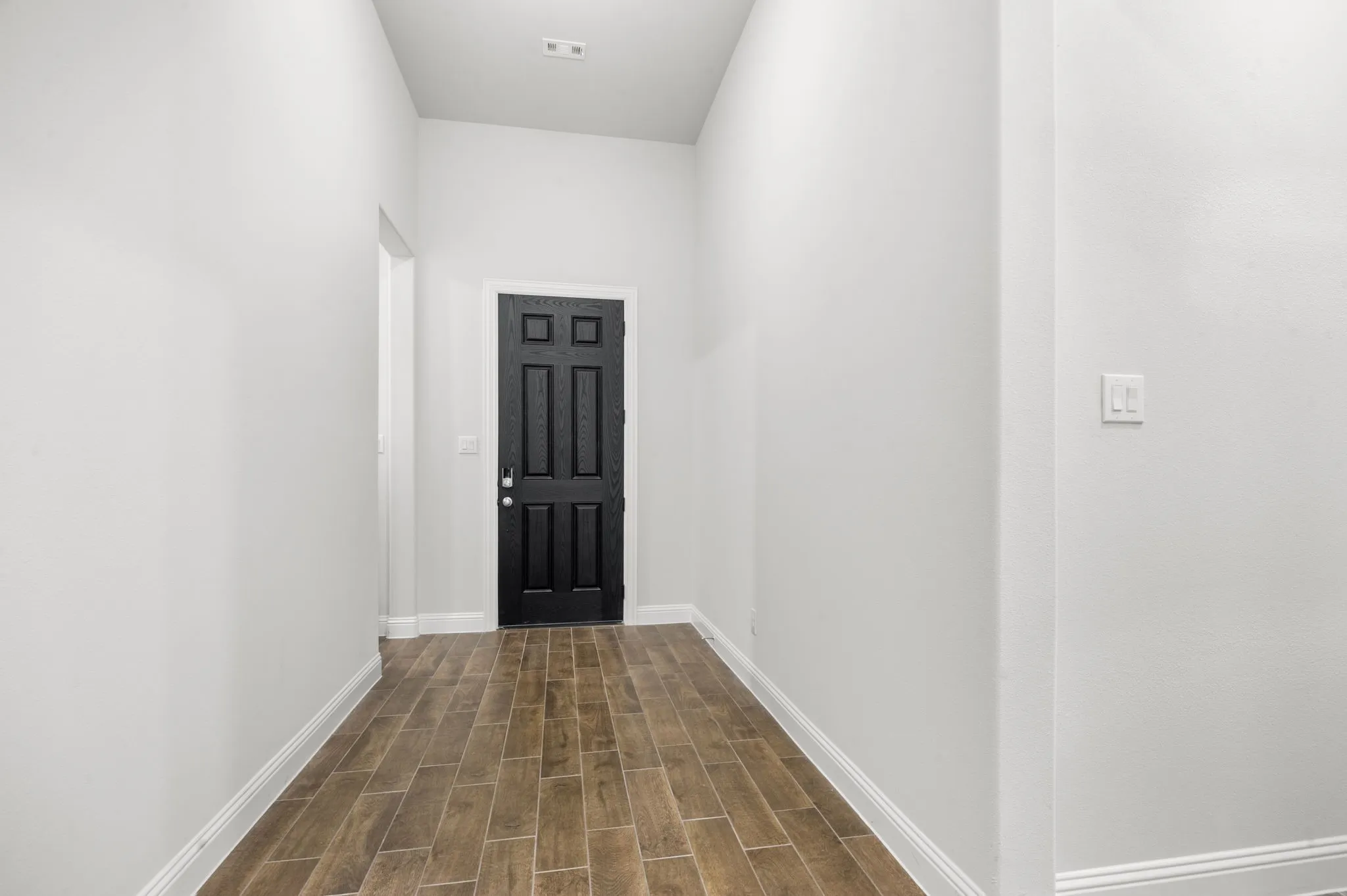 Entryway with dark hardwood / wood-style floors