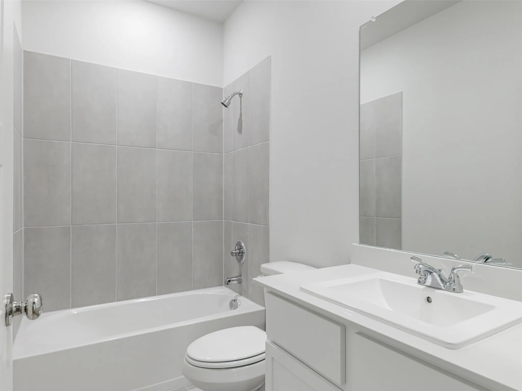Bathroom with a white vanity featuring a rectangular sink, chrome faucet, and a large wall-mounted mirror