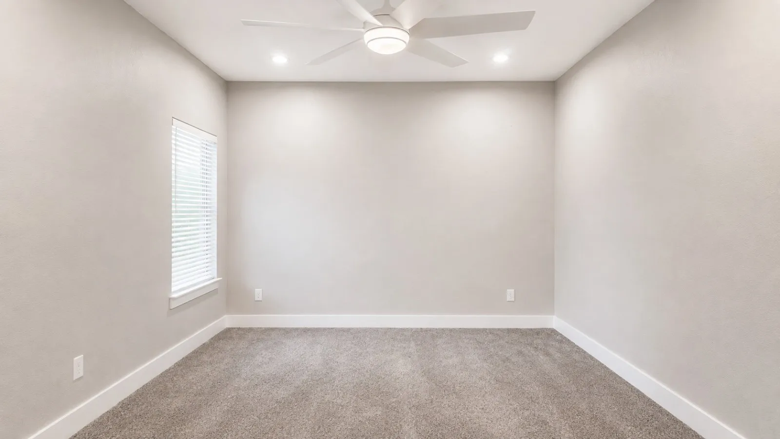 Recessed lighting, modern ceiling fan, single window with blinds, light gray wall finish, and gray carpeting