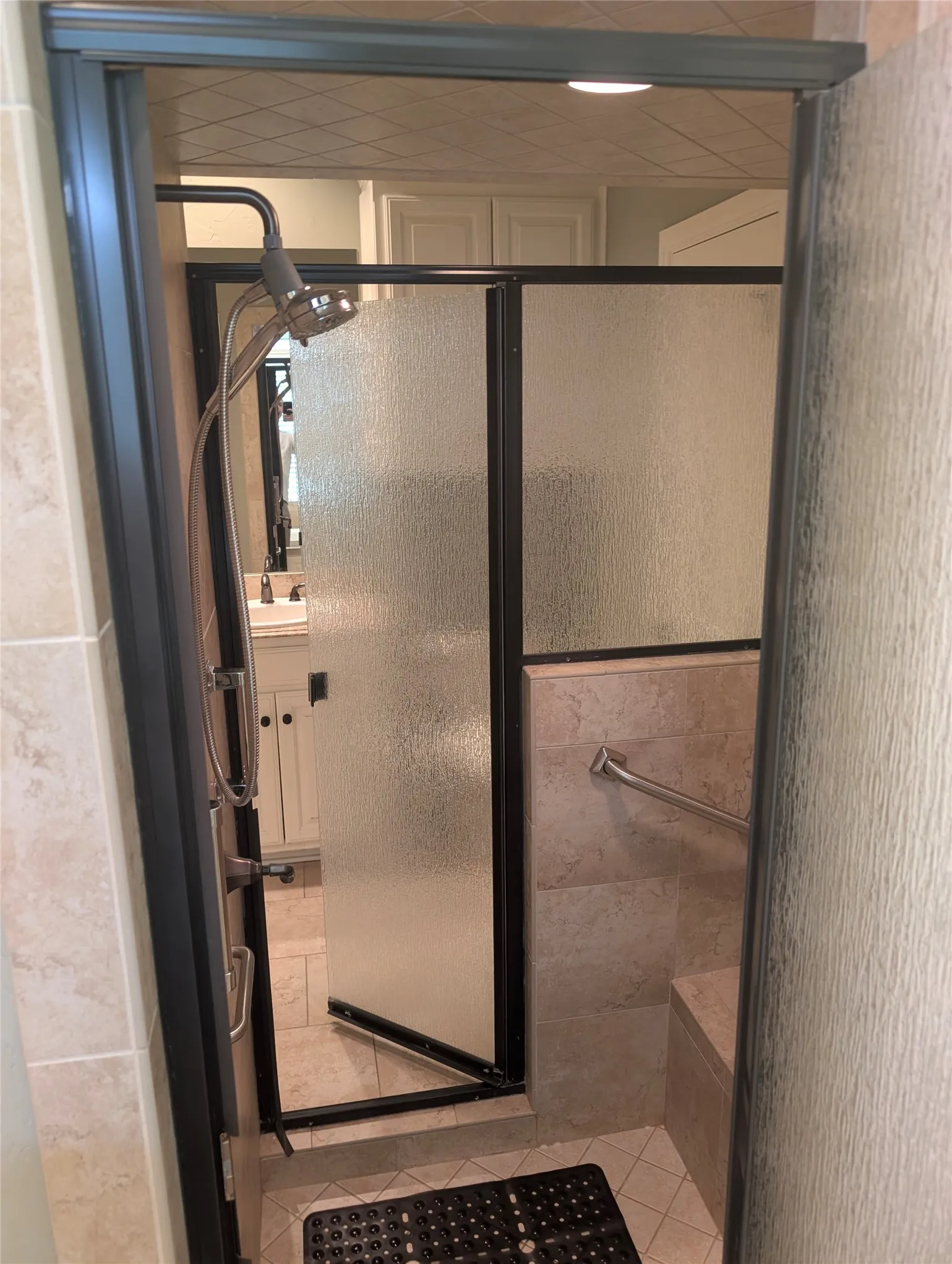 Walk-through shower to both sides of the split primary bedroom.