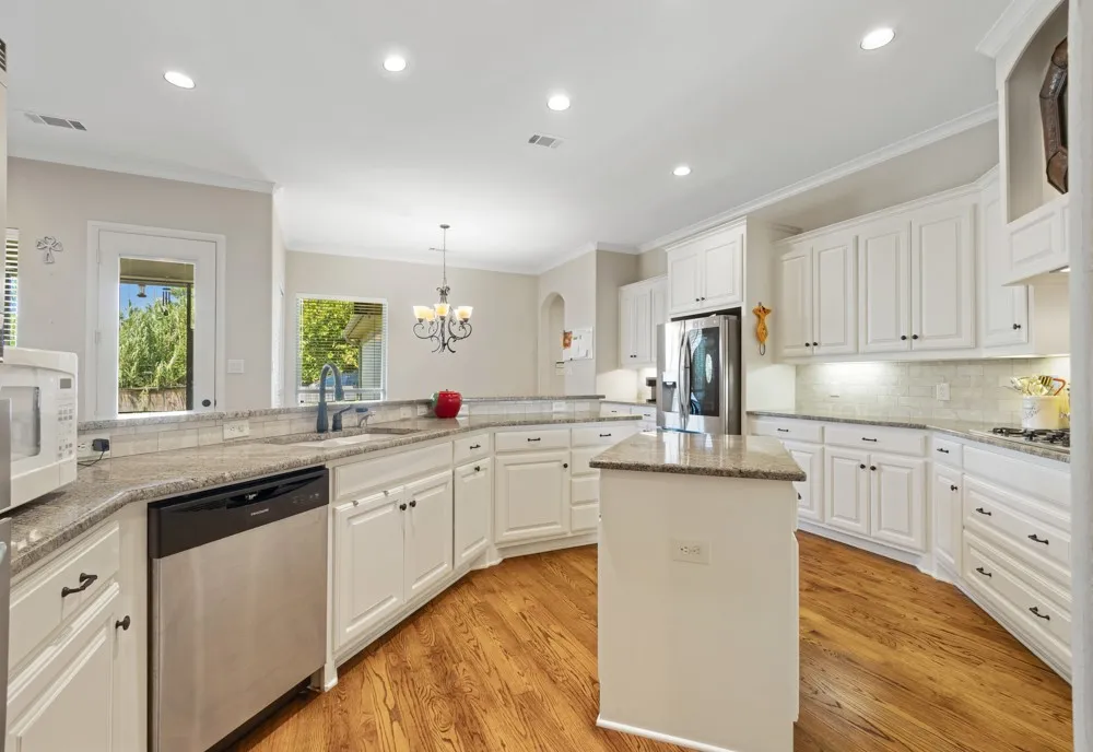 kitchen with granite countertops, lots of cabinets and breakfast area.