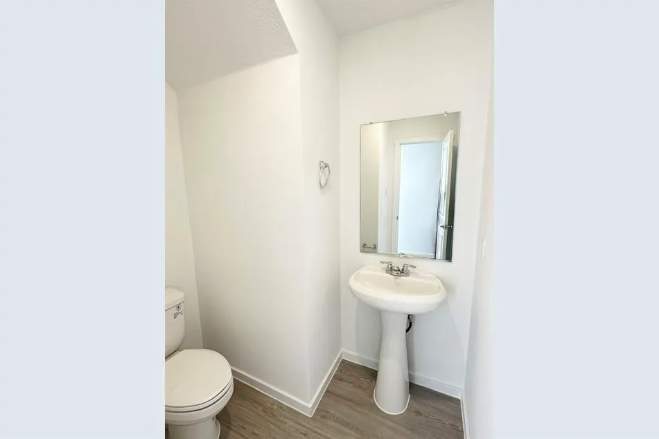 Bathroom with wood-type flooring, sink, and​​‌​​​​‌​​‌‌​‌‌​​​‌‌​‌​‌​‌​​​‌​​ toilet