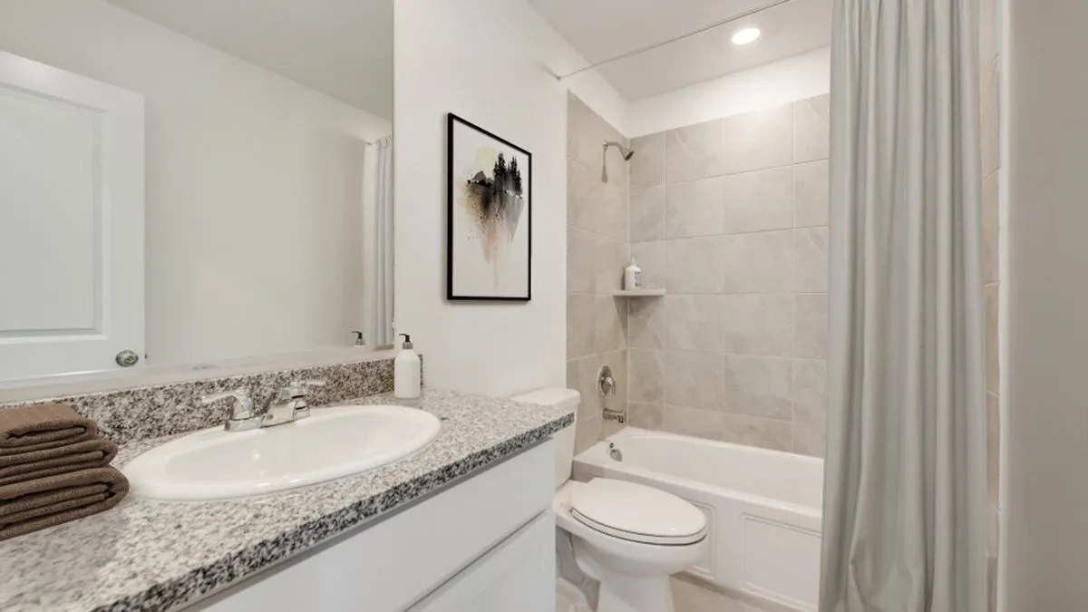 Full bathroom featuring shower / tub combo, vanity, and toilet