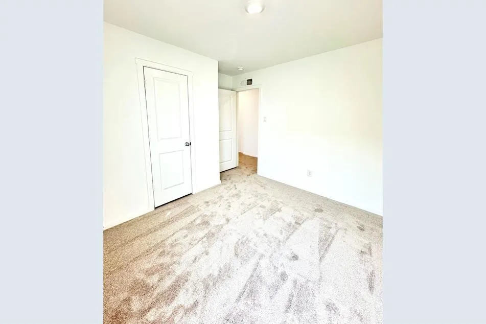 Unfurnished bedroom featuring light colored carpet