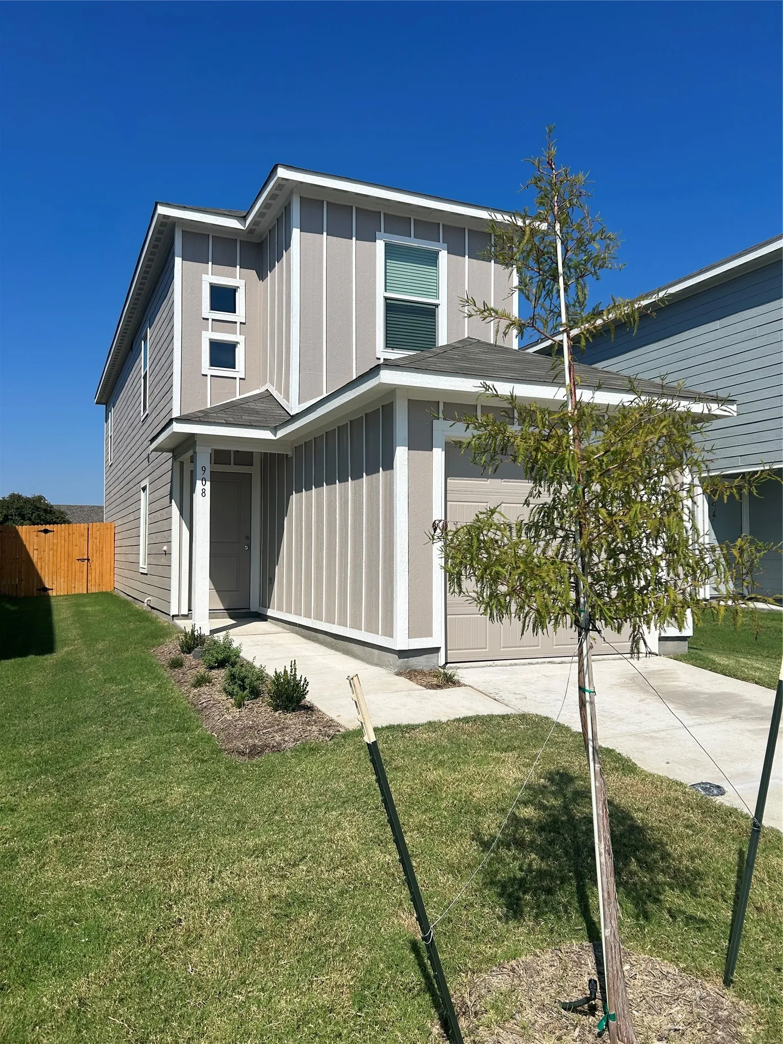 View of front of house with a front yard and a garage