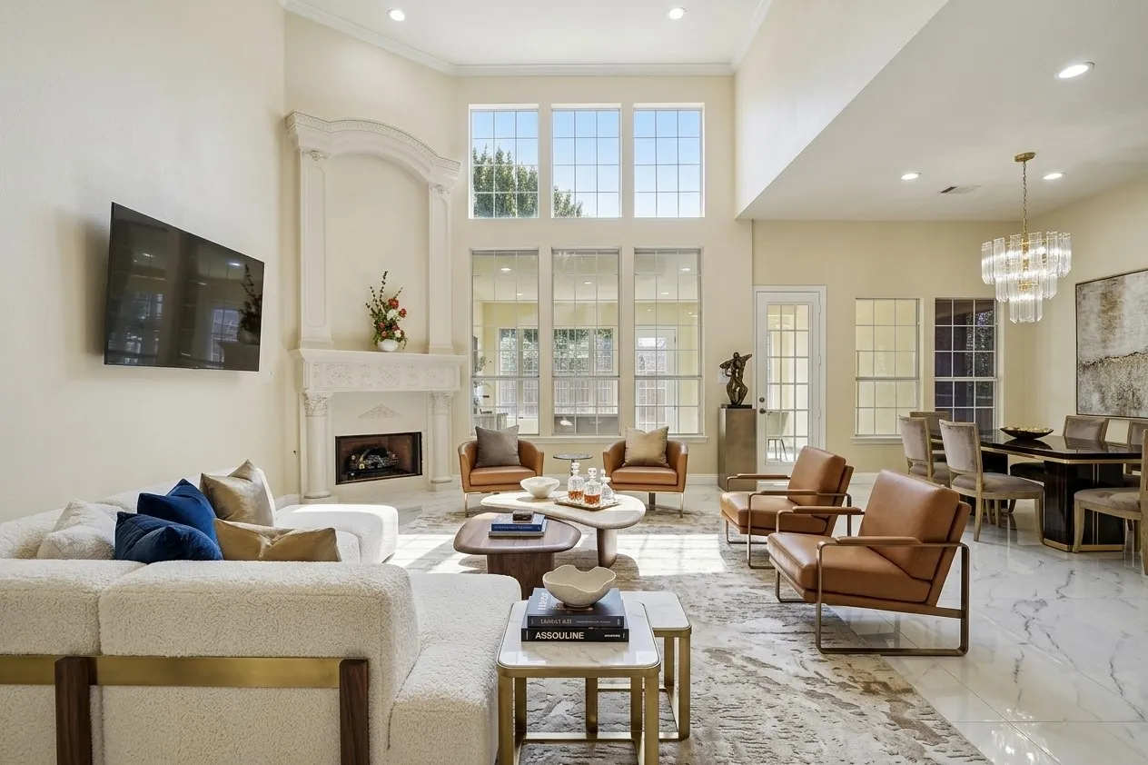 AI Staged, Spacious living area featuring high ceilings, a decorative fireplace with an ornate mantel, and large windows with grid accents