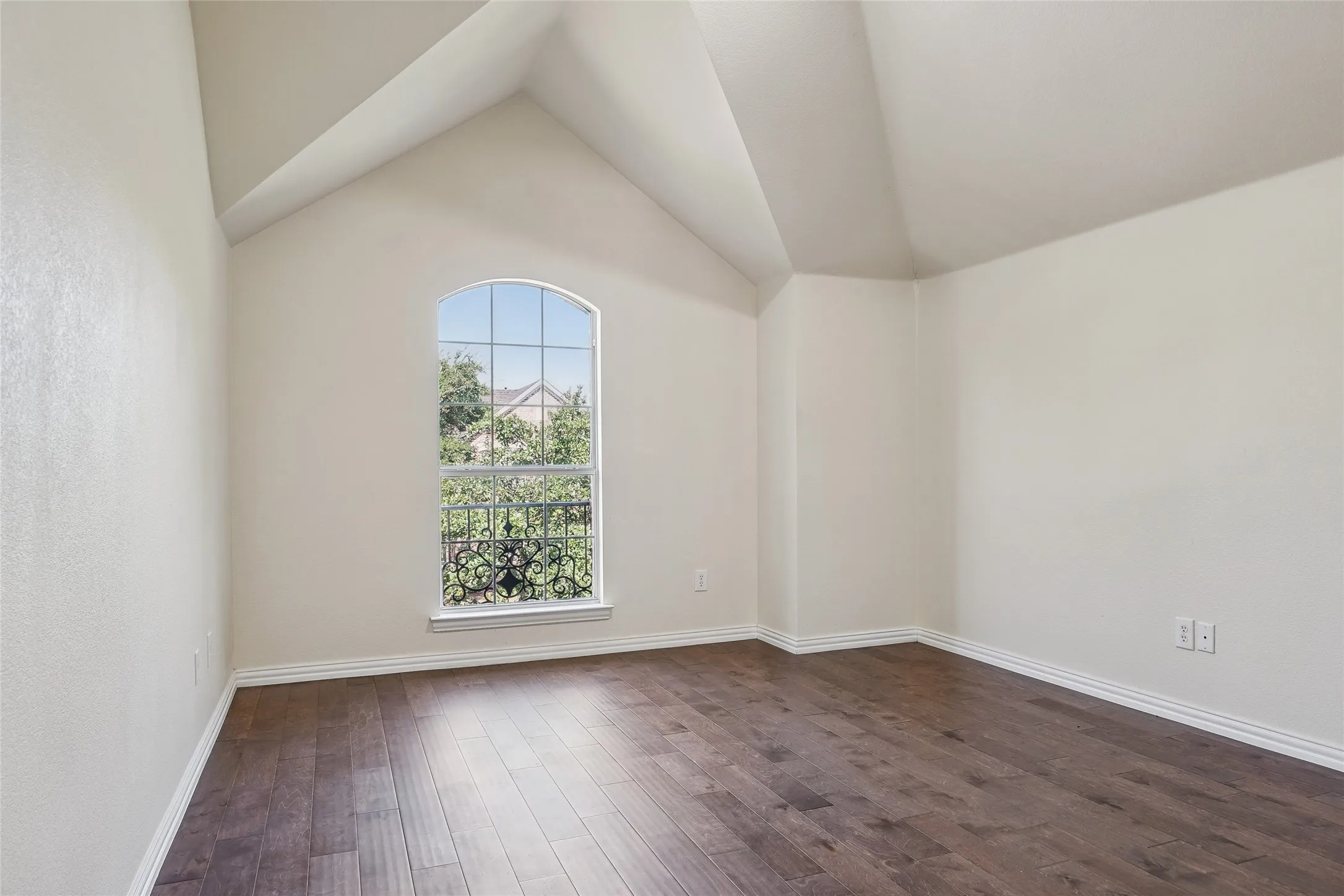Arched window with decorative ironwork