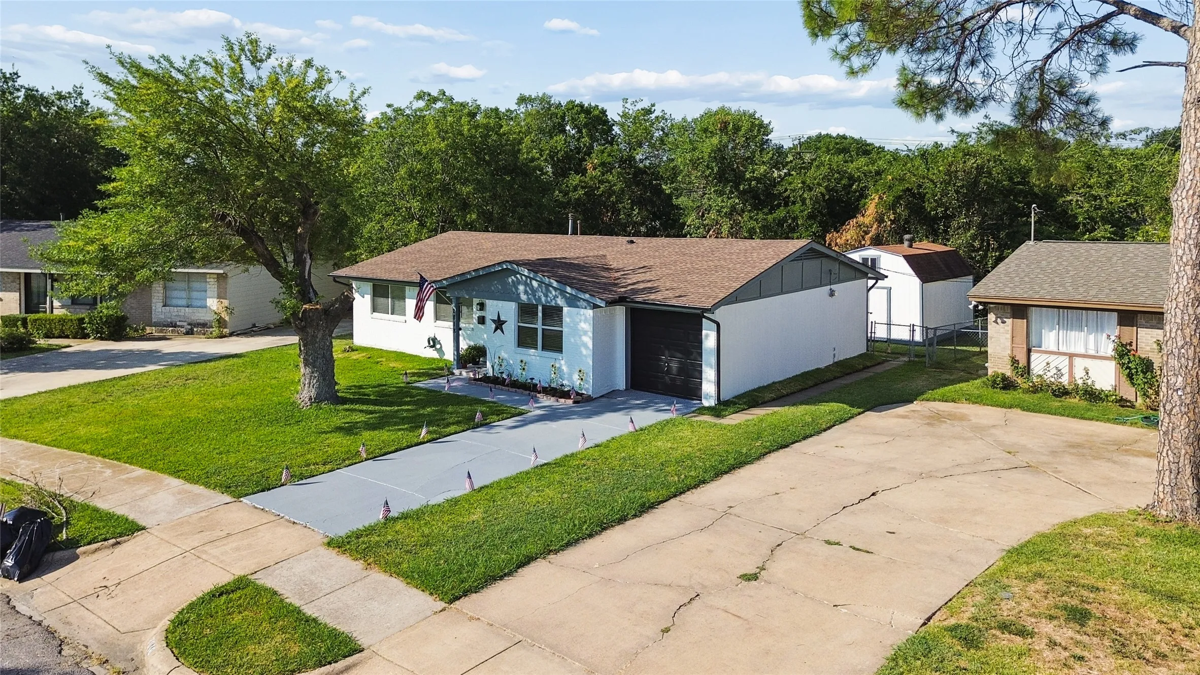 Single-story residence featuring a brown shingle roof and a two-tone exterior