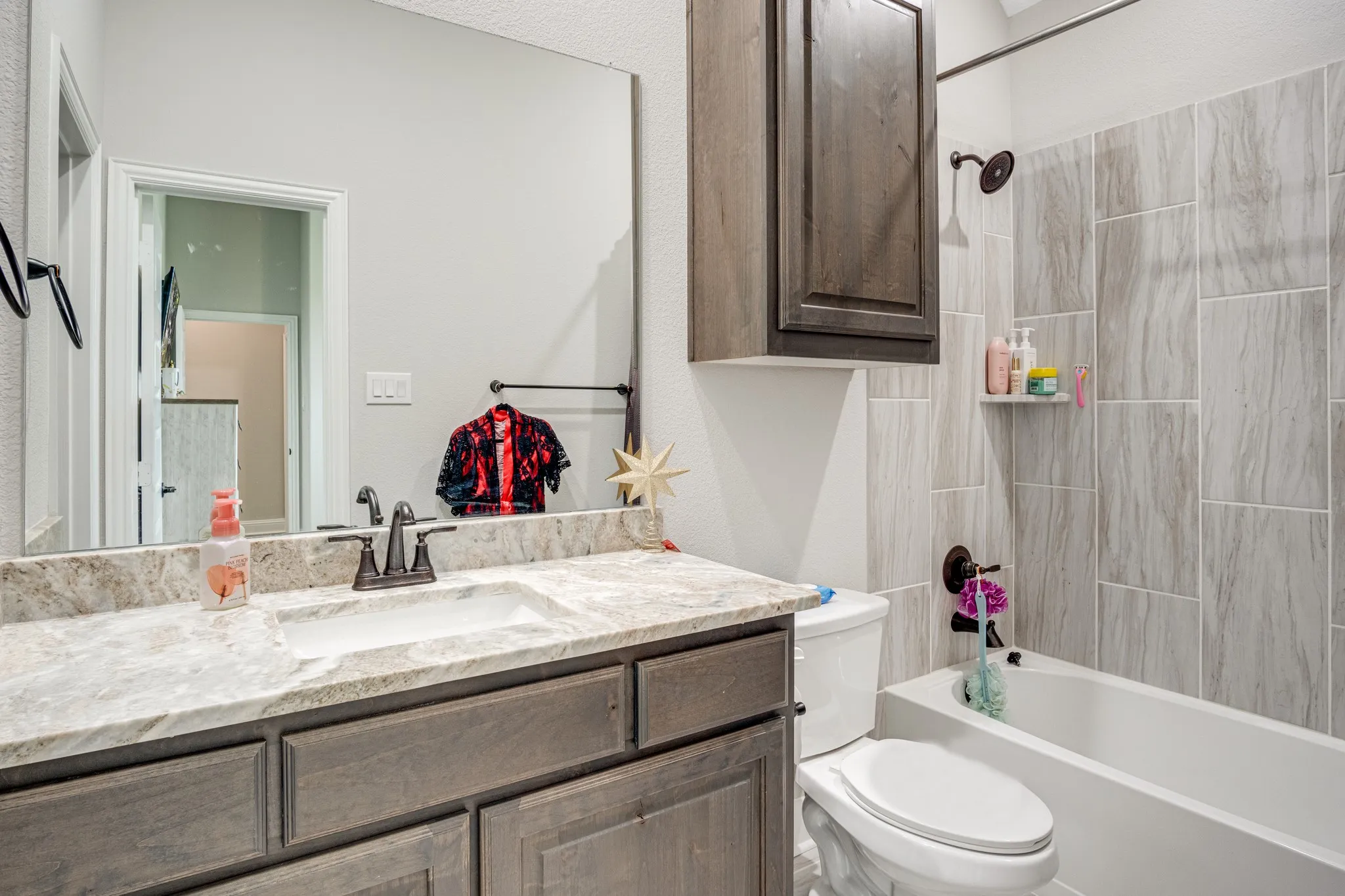 Bathroom featuring a vanity with a light-toned countertop and an undermount sink