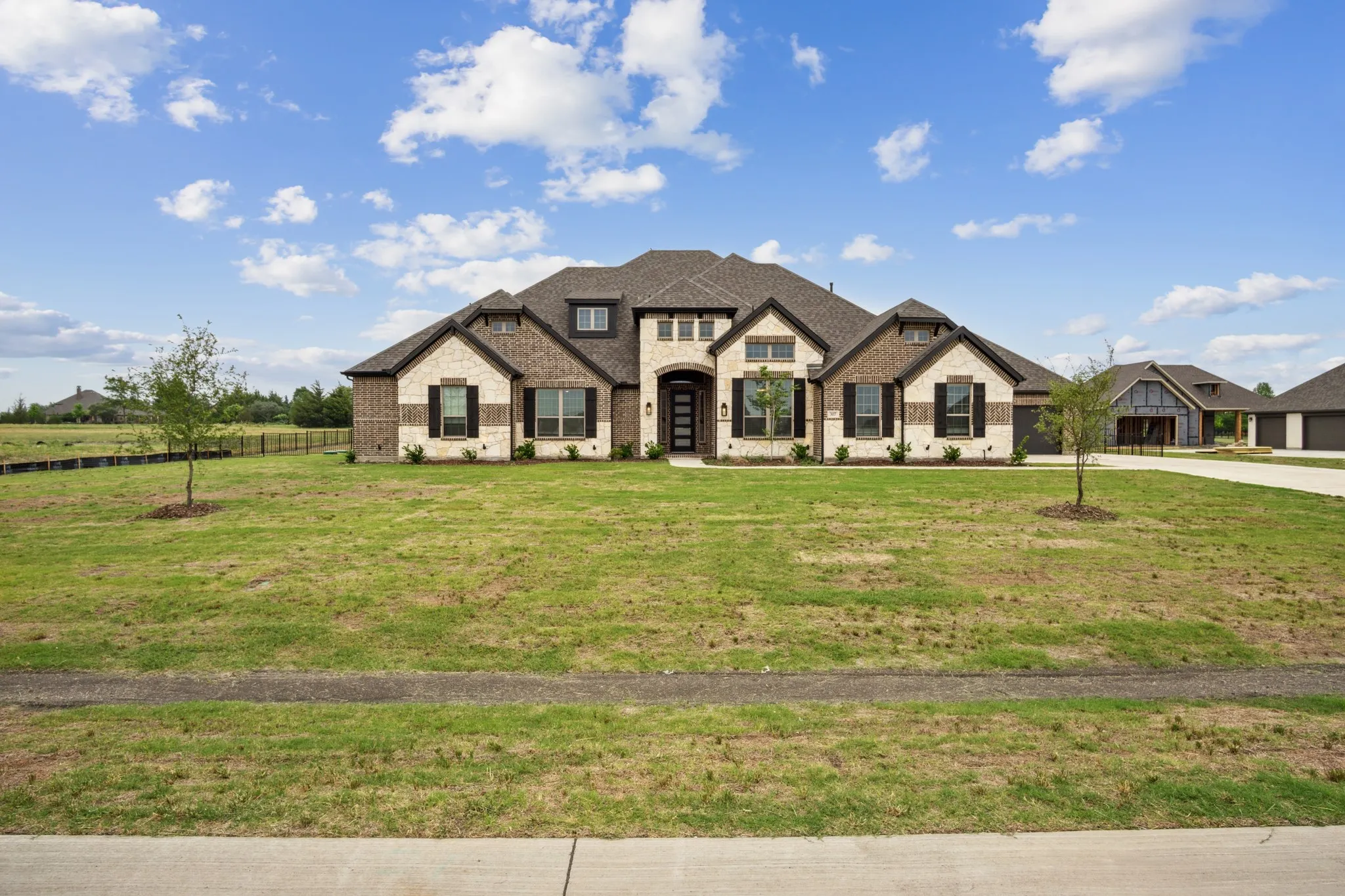 Stately brick and stone exterior with dark trim accents