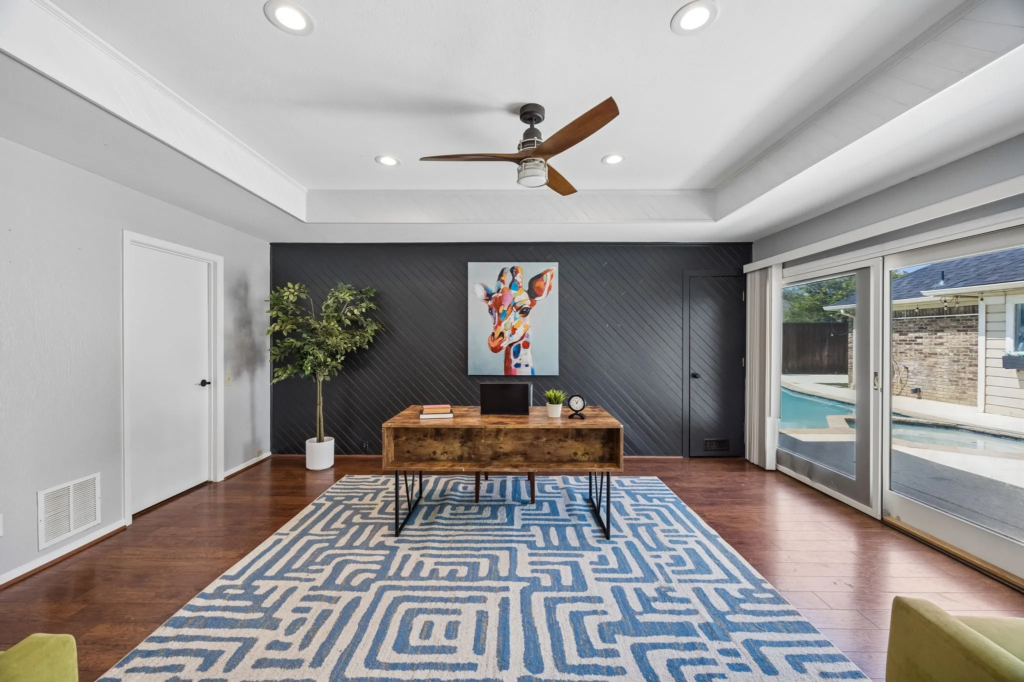 Interior room featuring wood-finish flooring, recessed lighting, and a tray ceiling