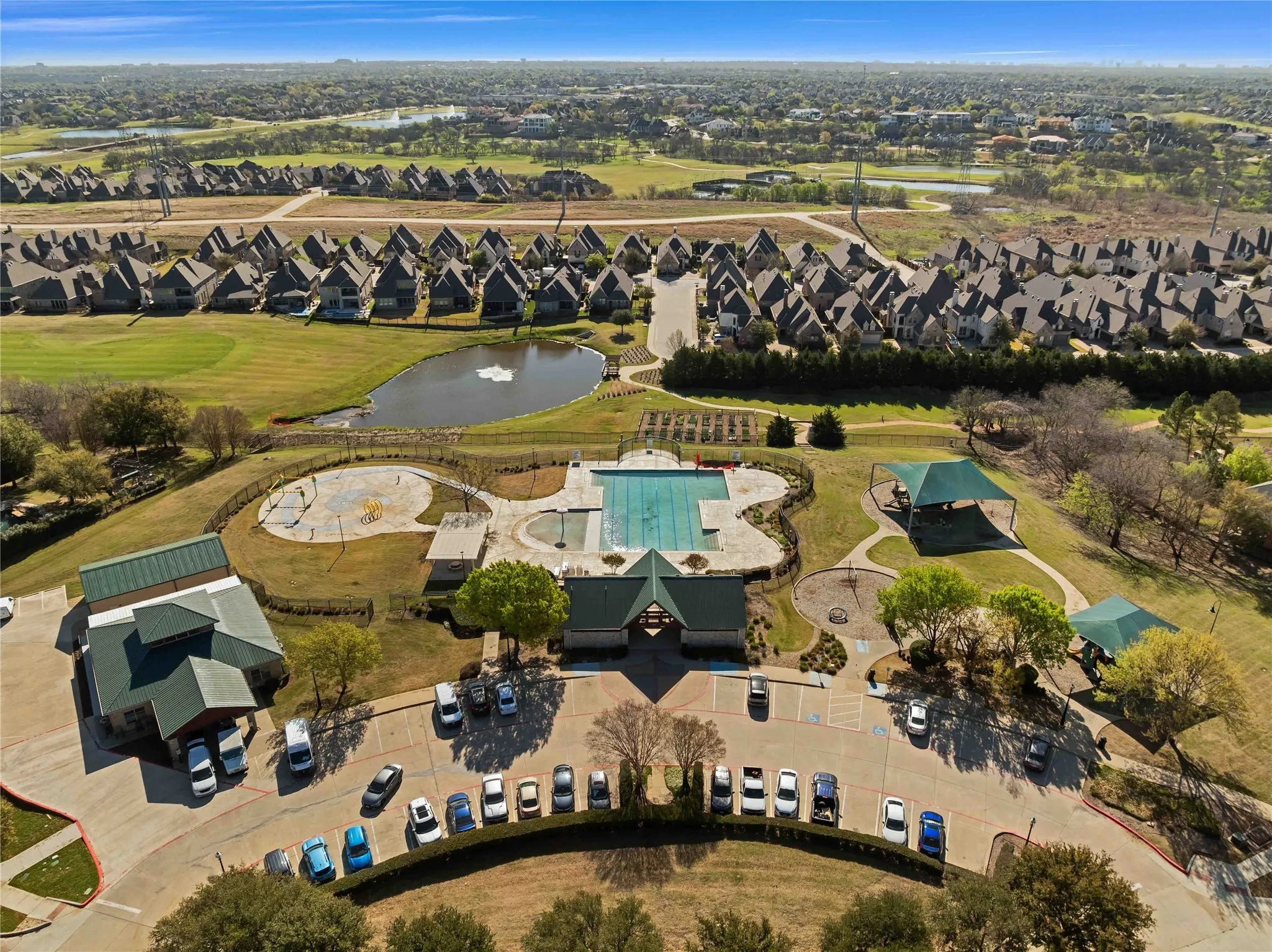 Community amenities featuring a swimming pool, covered gathering areas, and extensive green spaces