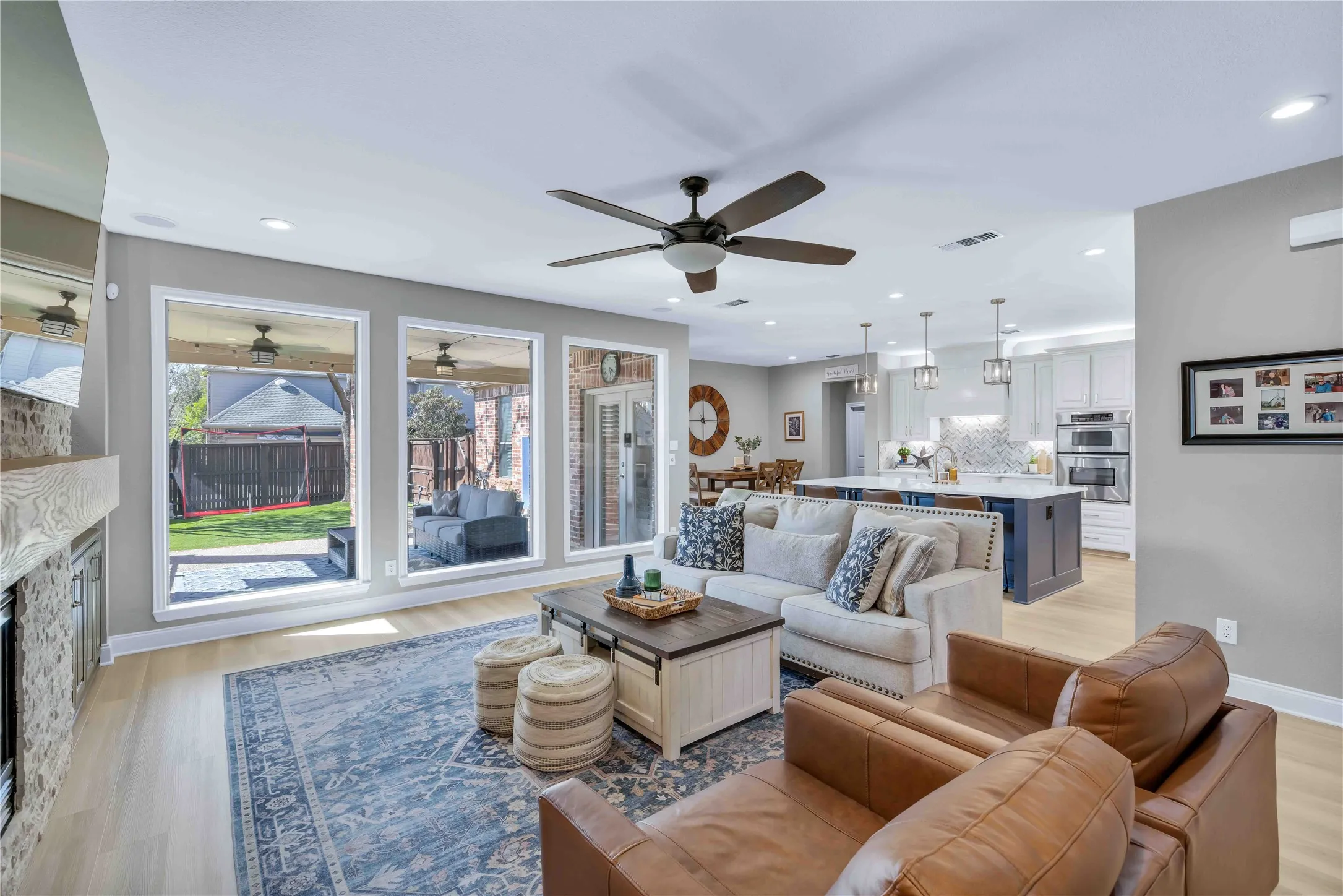 Spacious living area featuring light wood-finish flooring and recessed lighting