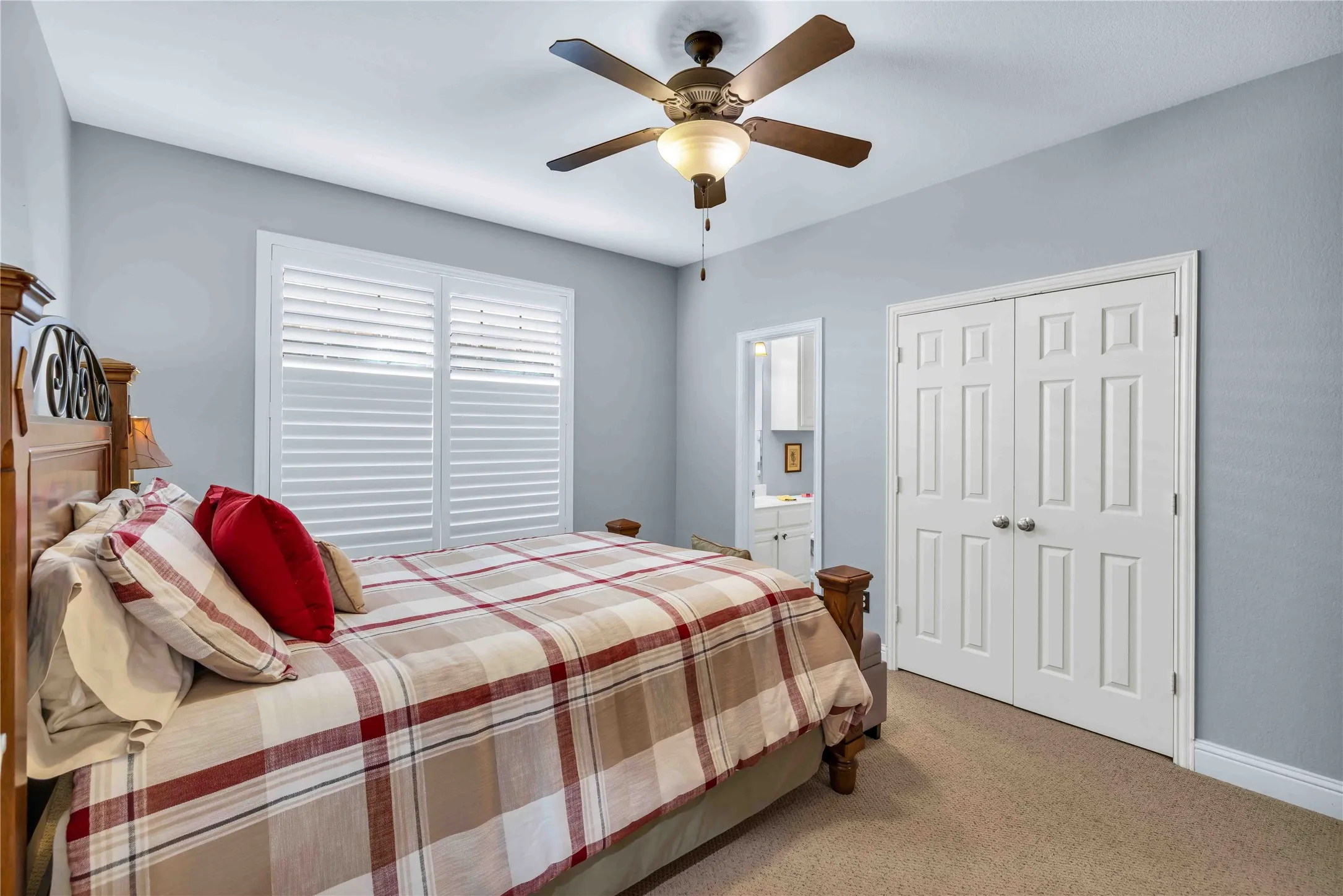 Downstairs, Bedroom featuring neutral-toned walls, a ceiling fan with integrated lighting, and carpet flooring