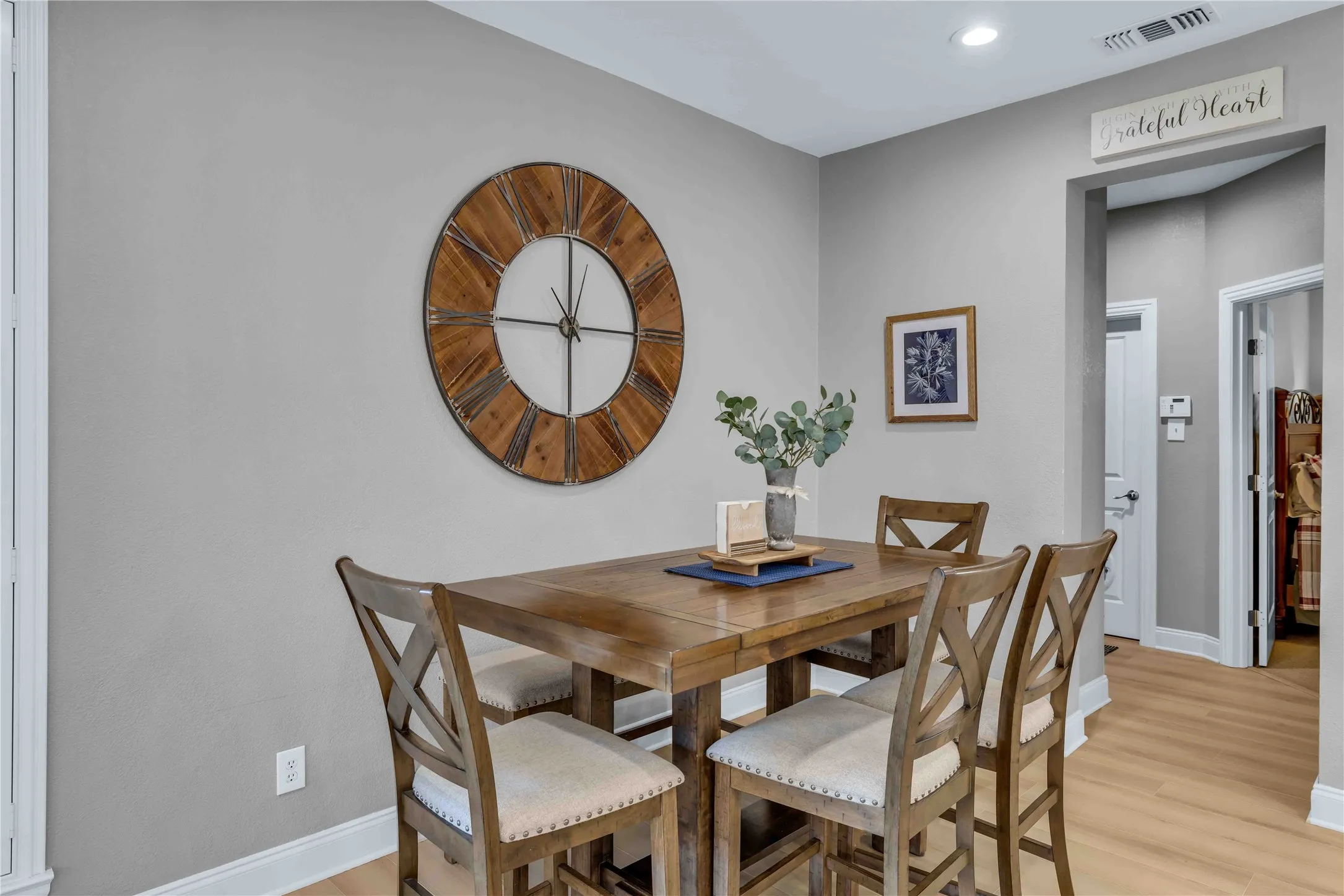 Dining area featuring wood-finish flooring, recessed lighting, and a light gray wall color