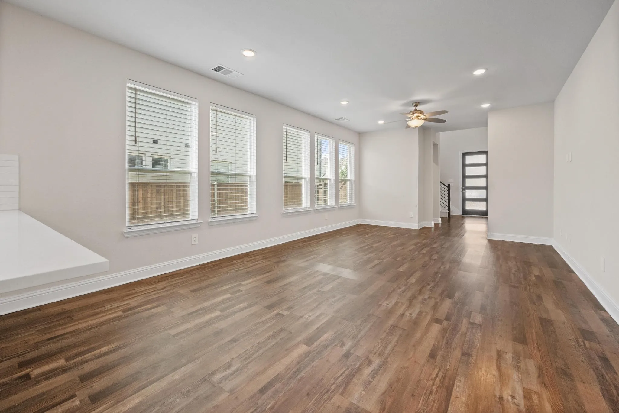 Open concept living space featuring wood-finish flooring