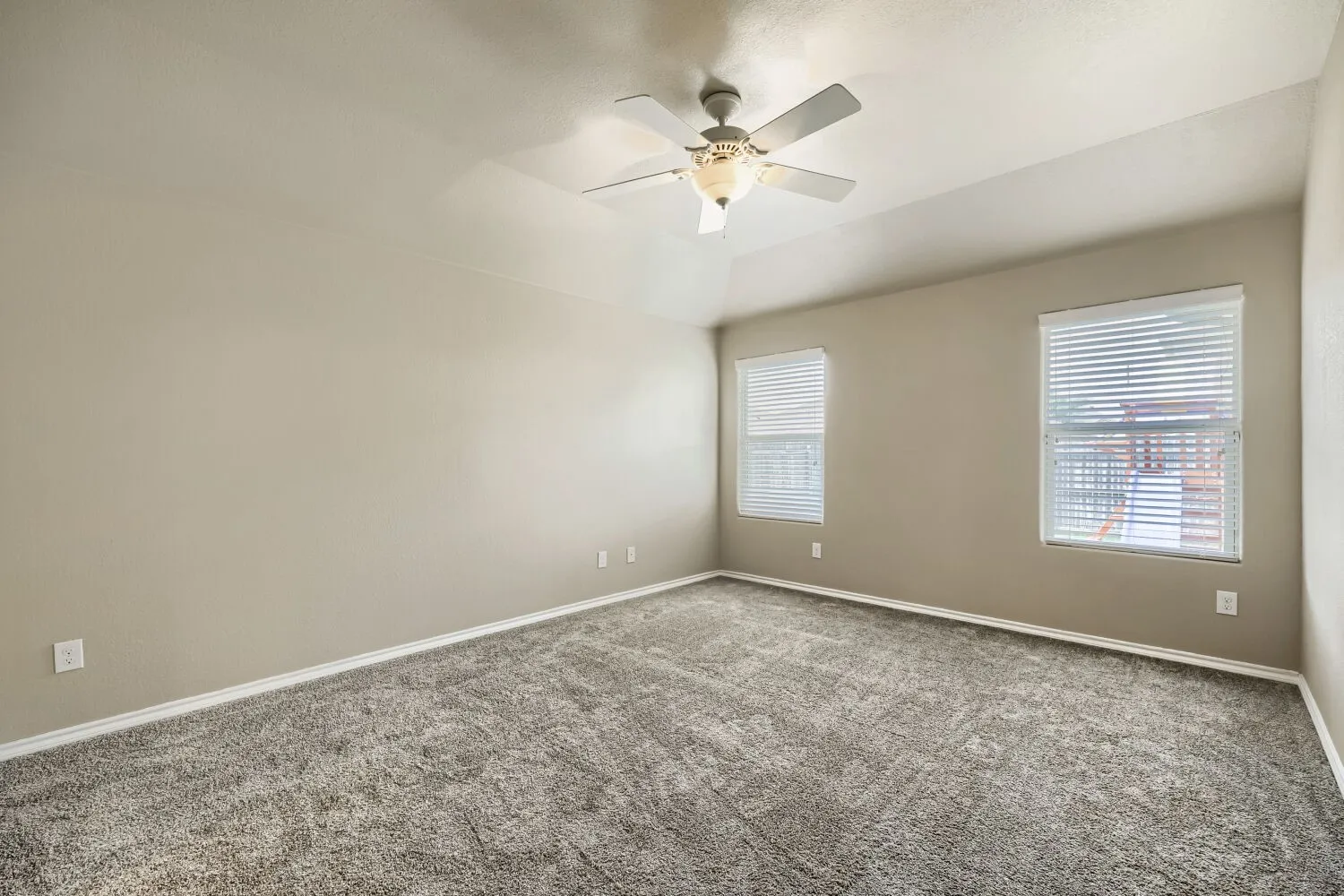 Neutral-toned walls complement the gray carpeting