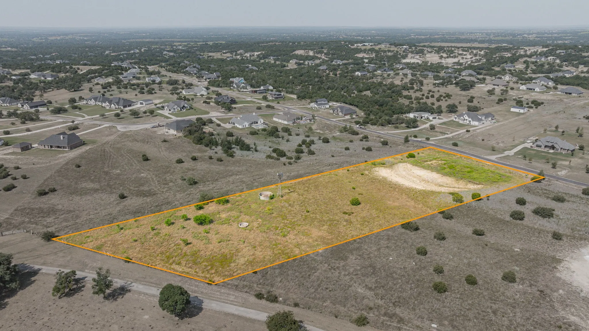 Expansive vacant land featuring approximately 40+ acres of gently rolling terrain with scattered mature oak trees