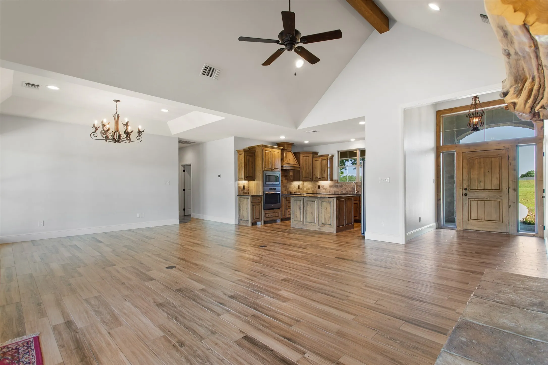 LIVING ROOM, FRONT ENTRY, AND KITCHEN AREA