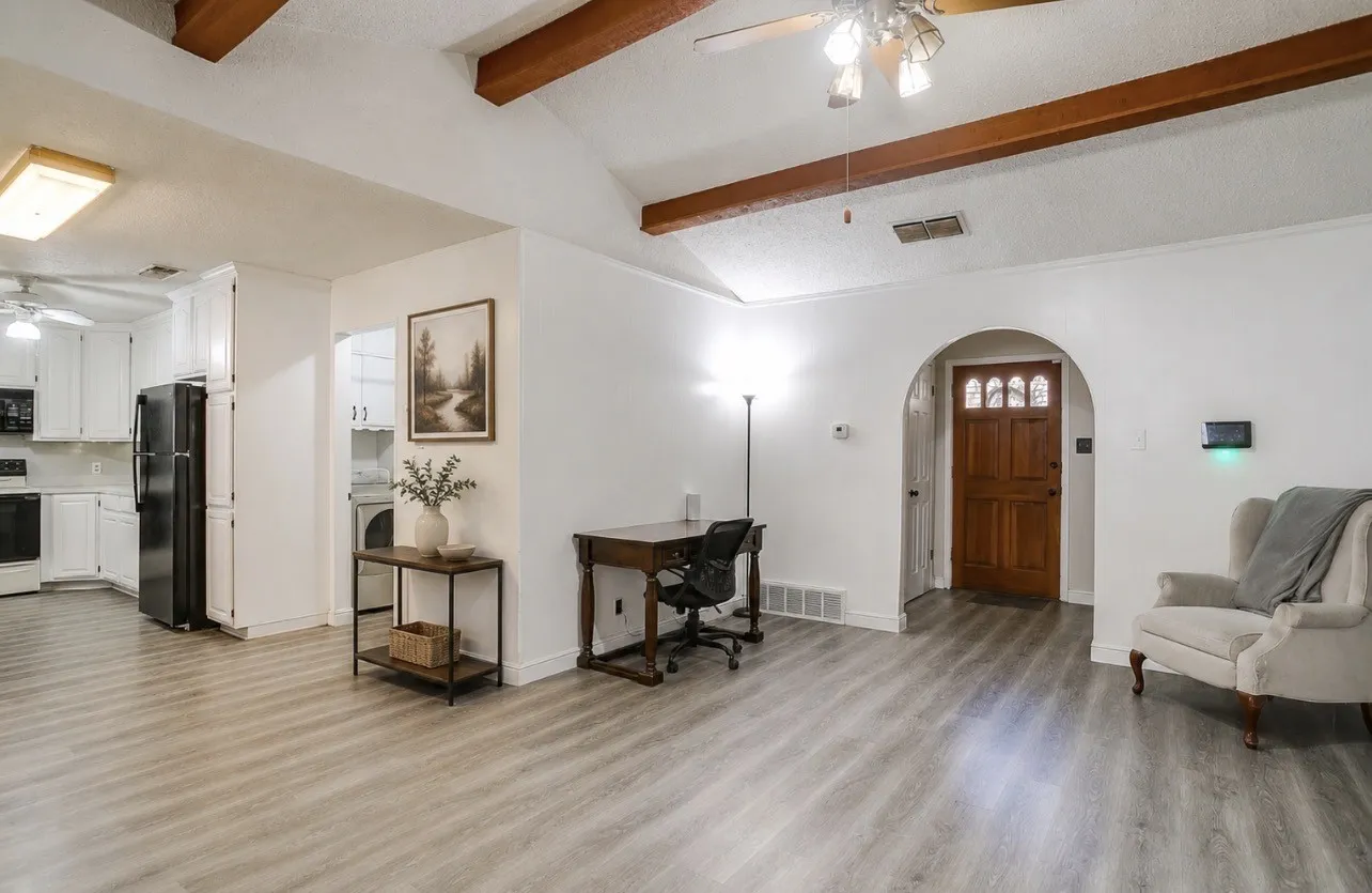 virtually staged entryway, into kitchen and living