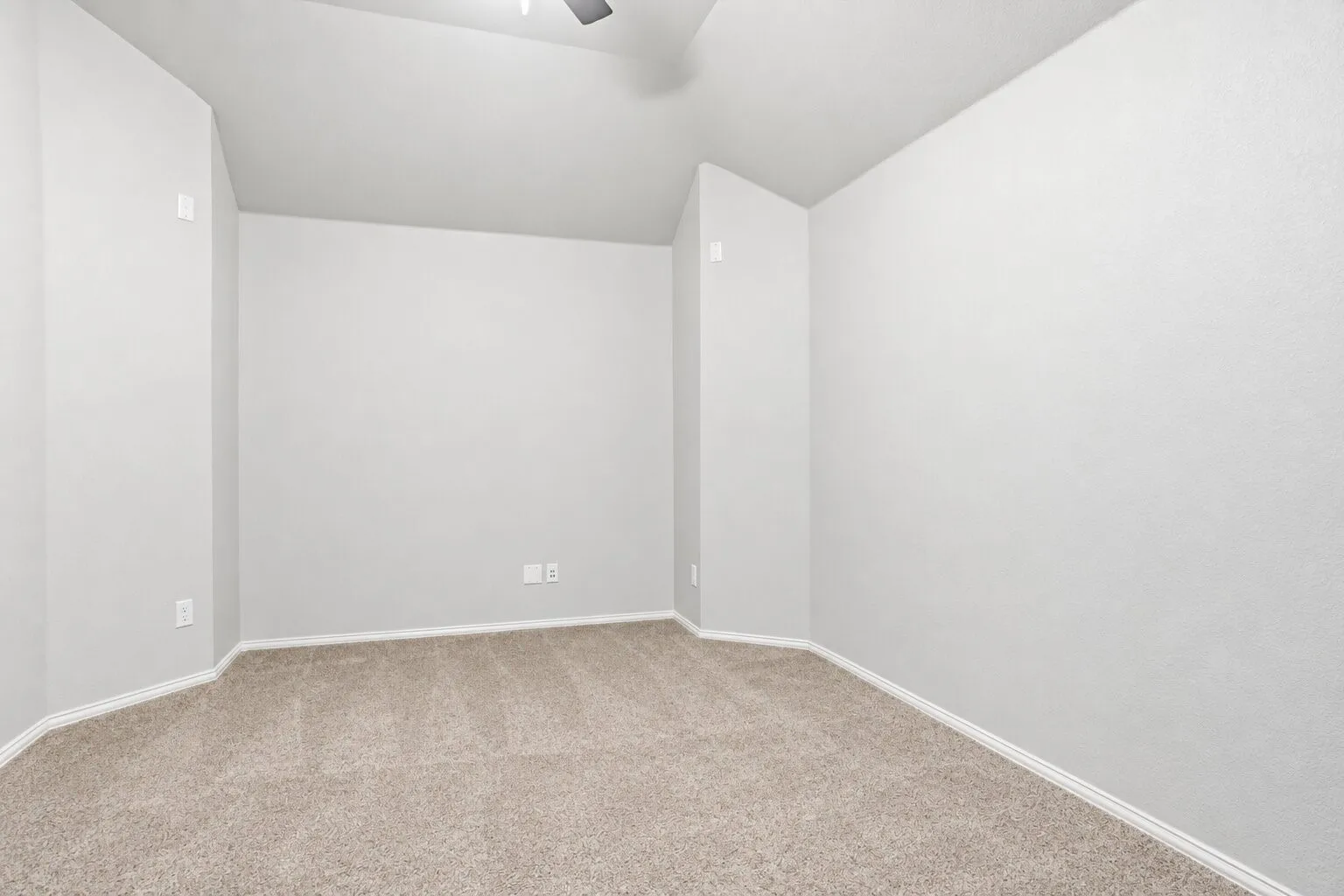 Upstairs media room currently used as a home gym, featuring vaulted ceilings, wall-length mirrors, and a spacious, flexible layout for fitness, movies, or entertainment. Photos have been AI enhanced for presentation; no material property features were altered.