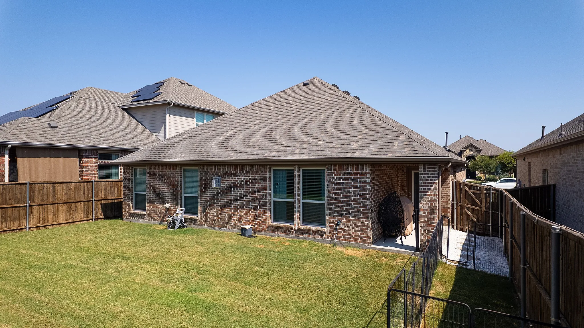 Brick exterior featuring a gabled roof and covered patio