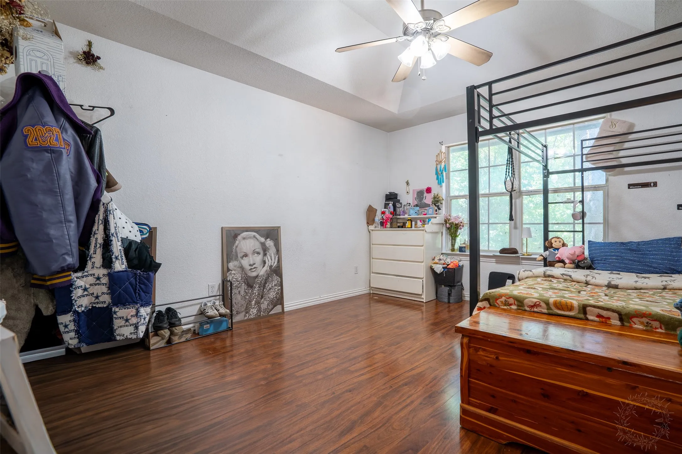 Wood-finish flooring extends throughout the room and into the hallway