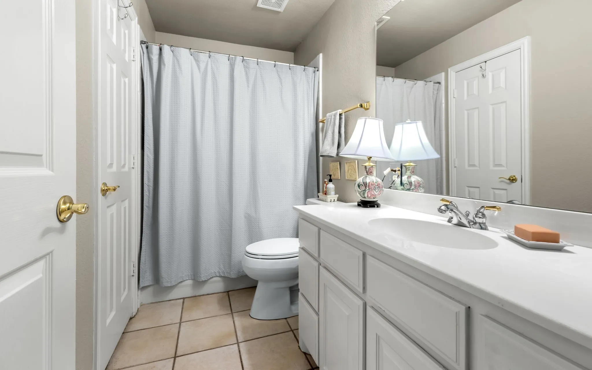 White vanity with an integrated sink and chrome faucet