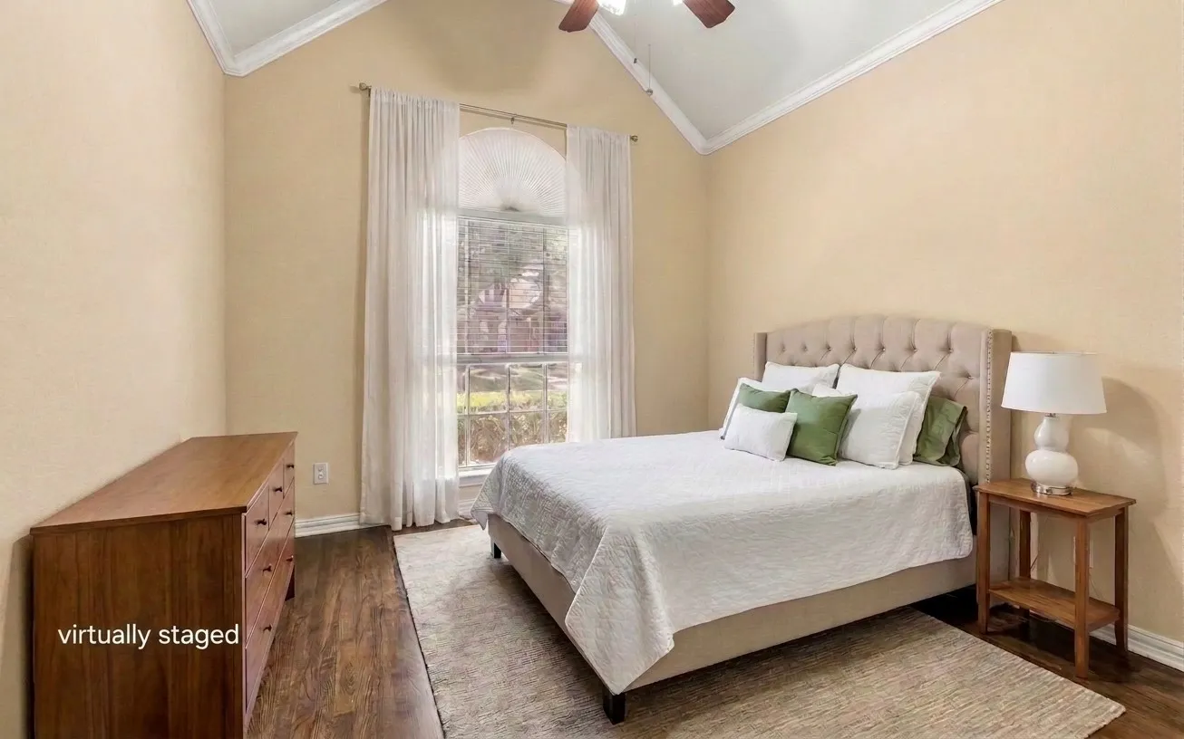 Vaulted ceiling with crown molding, wood-finish flooring, and a large window with blinds