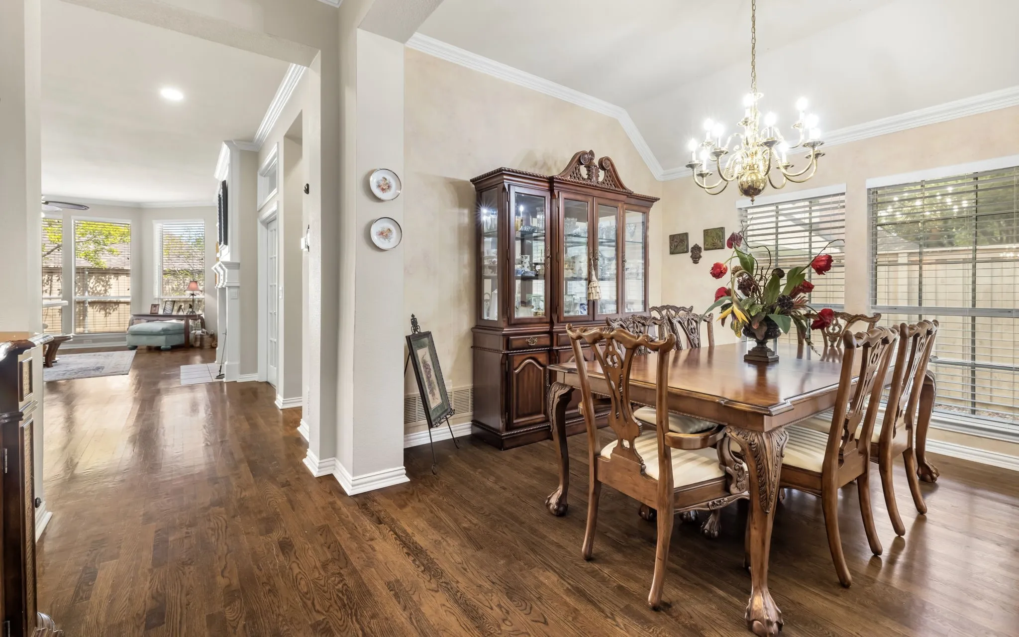 Wood-finish flooring throughout, a decorative chandelier, and an arched entry