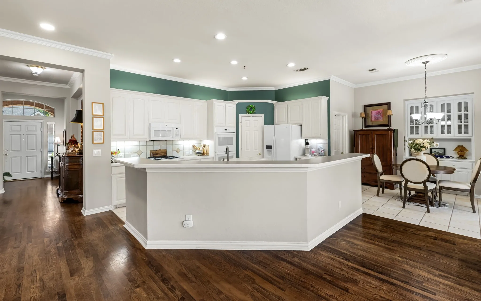 Kitchen with white cabinetry, stainless steel appliances, and a built-in microwave