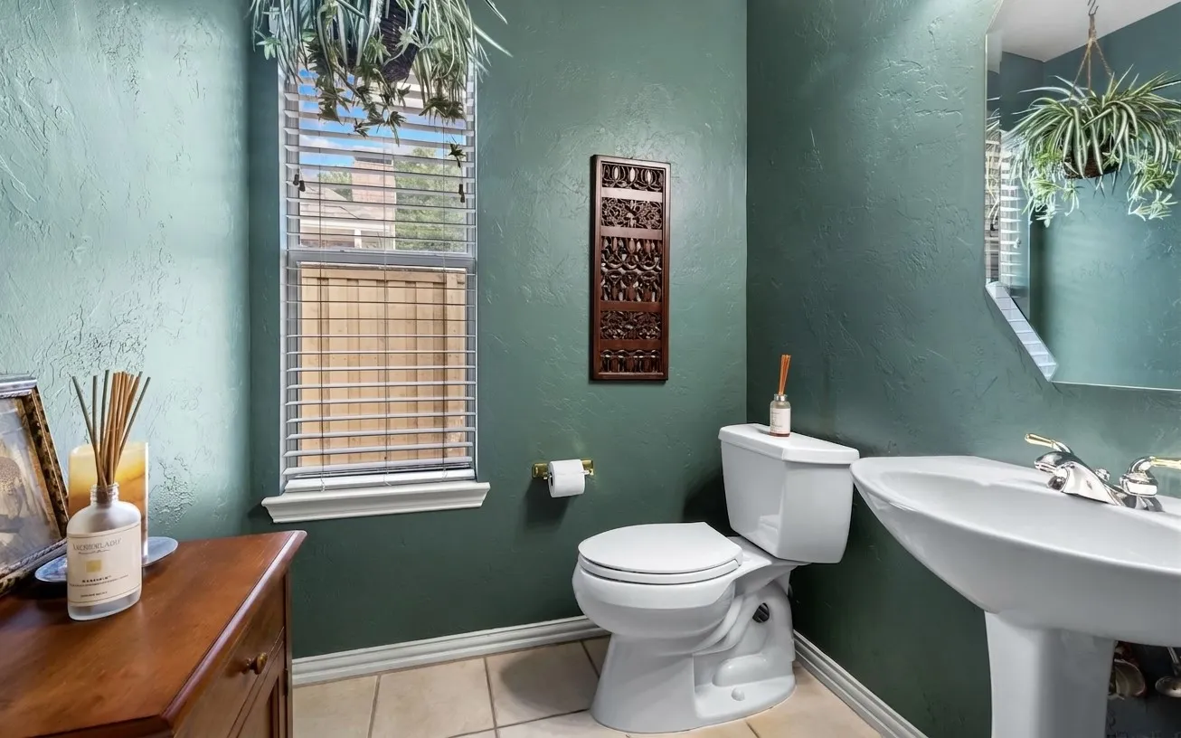 Recessed lighting, pedestal sink, wall-mounted mirror, ceramic tile flooring, and a window with blinds
