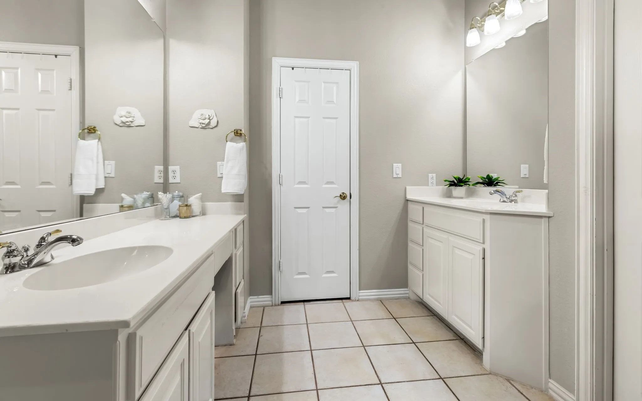 Dual vanity bathroom featuring white cabinetry with ample storage, ceramic tile flooring, recessed lighting, and white 6-panel interior doors