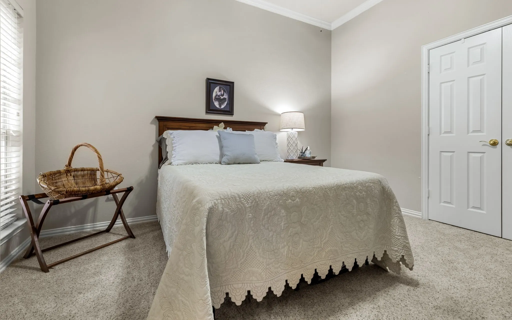 Neutral wall color, crown molding, double-panel closet doors, and carpeted flooring