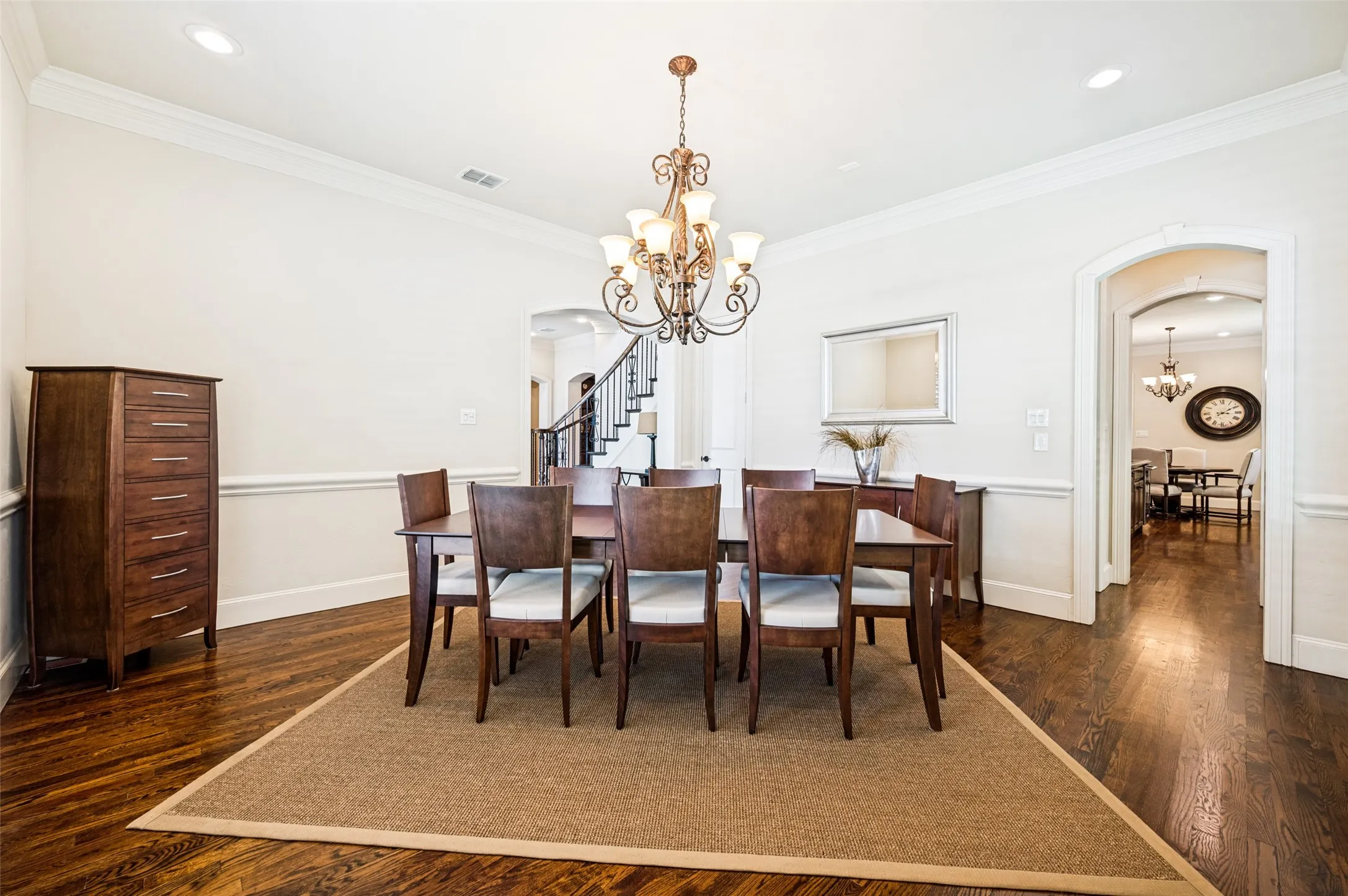 Formal dining area featuring dark wood-finish flooring