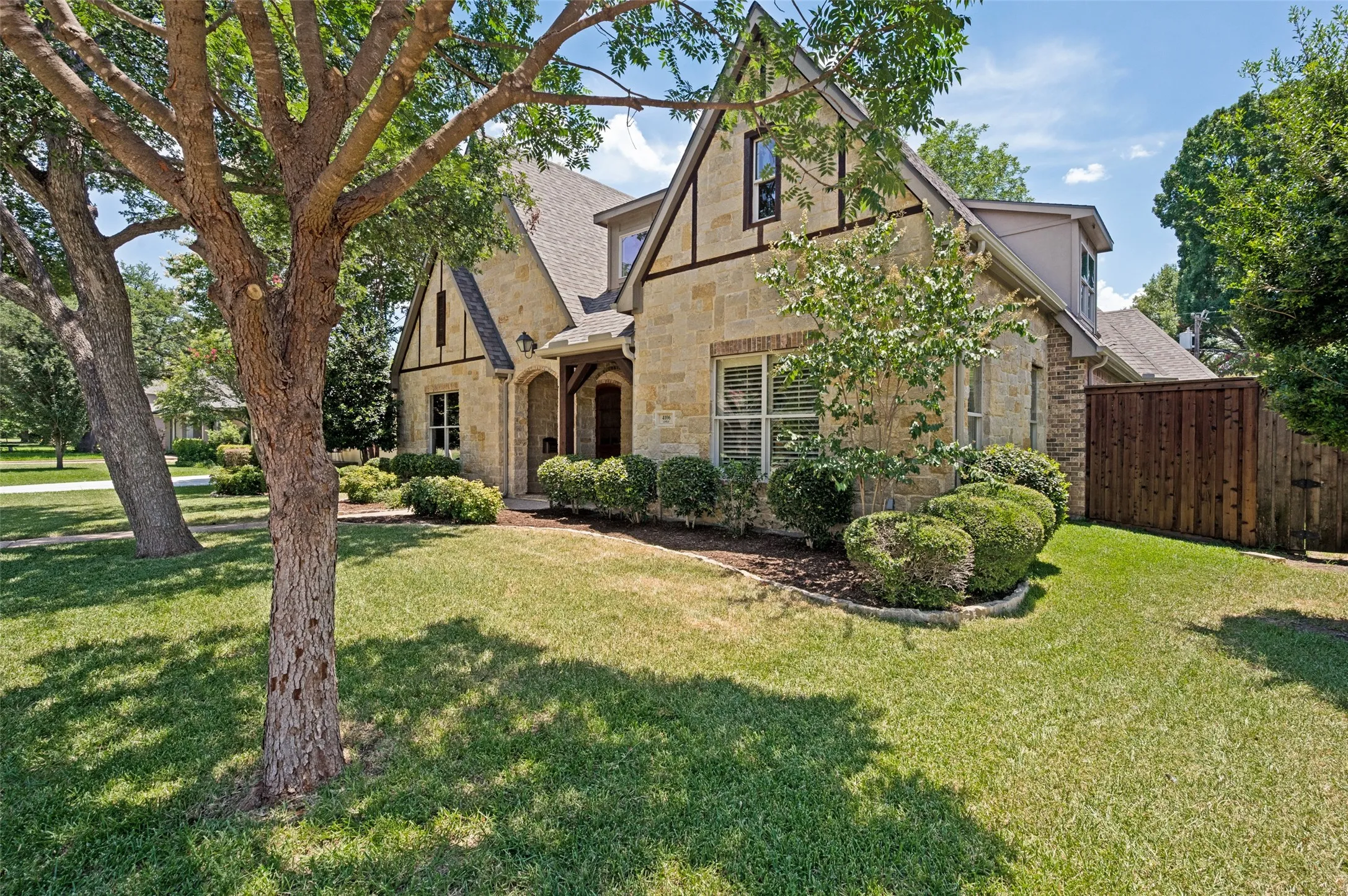 Stone and stucco exterior with dark trim detailing