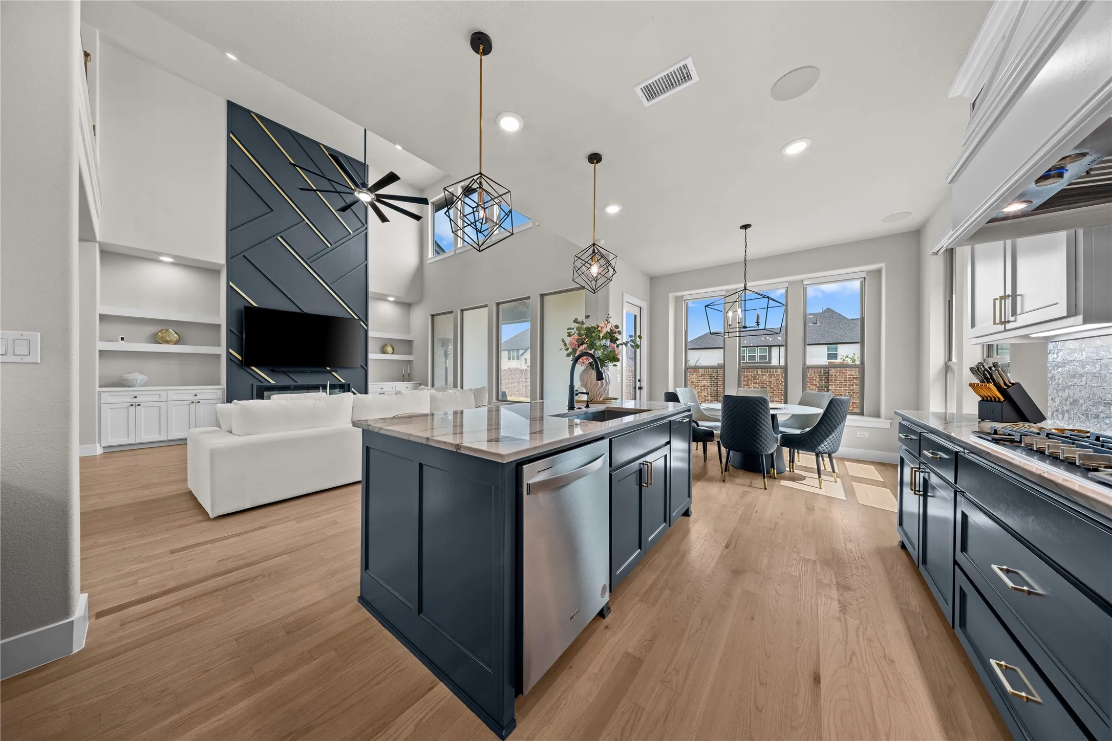 Open-concept living area with vaulted ceilings and wood-finish flooring